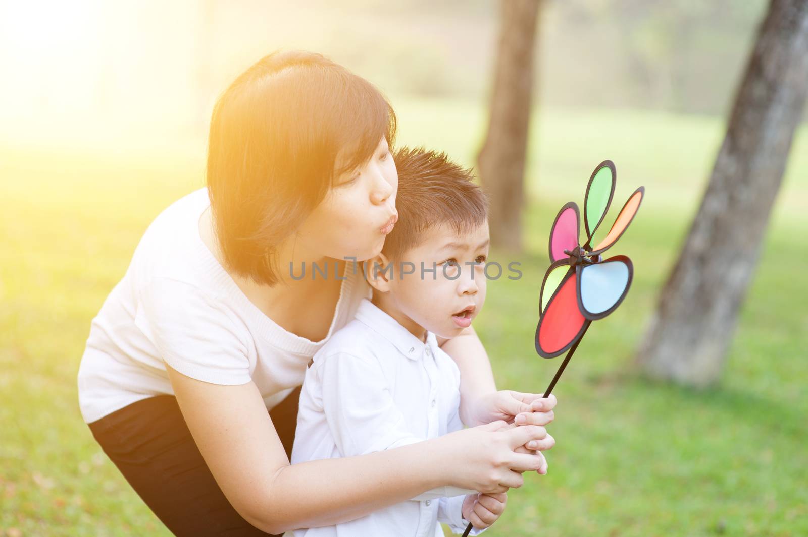 Mother and son playing outdoor. by szefei