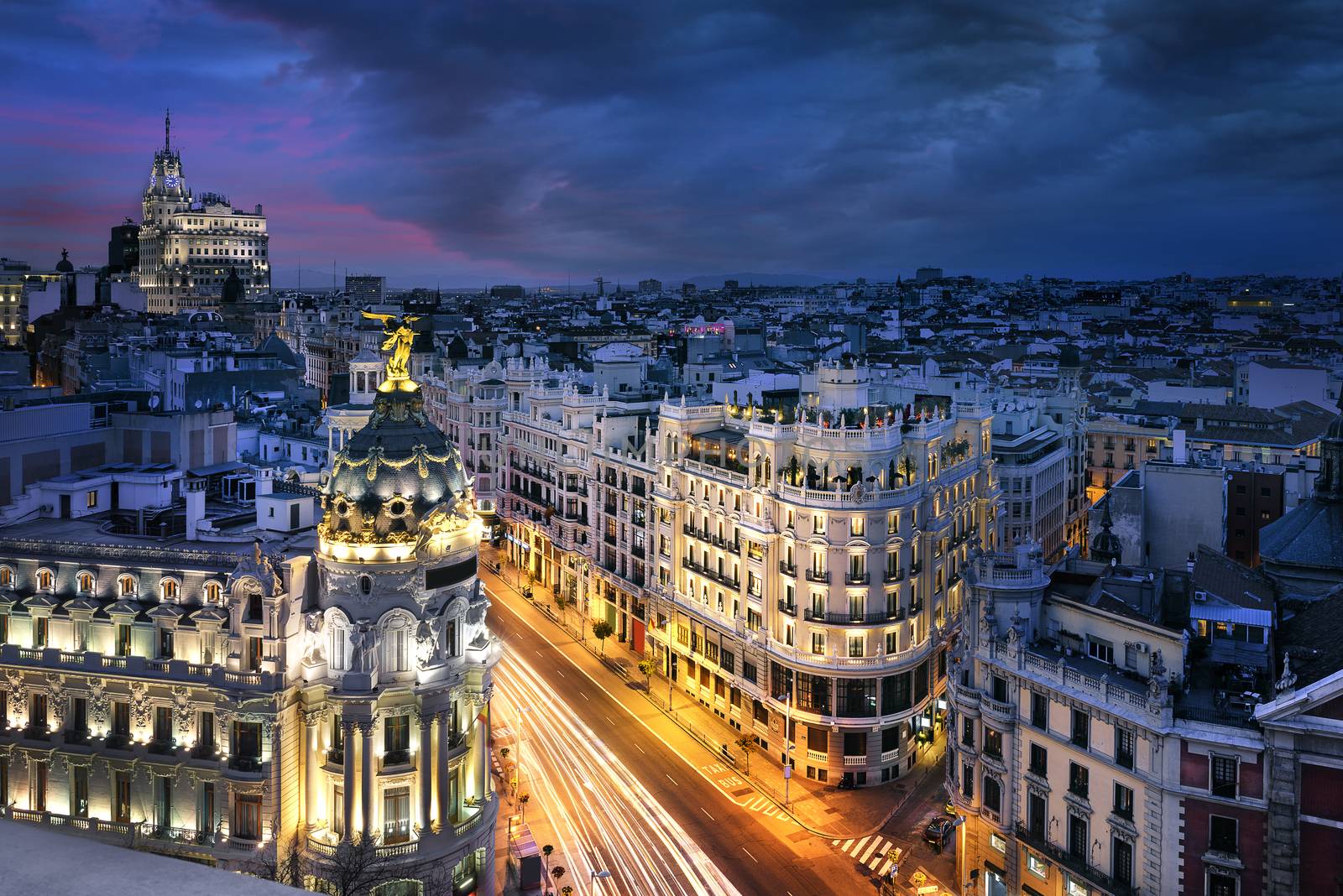 Rays of traffic lights on Gran via street, main shopping street in Madrid at night. Spain, Europe. 