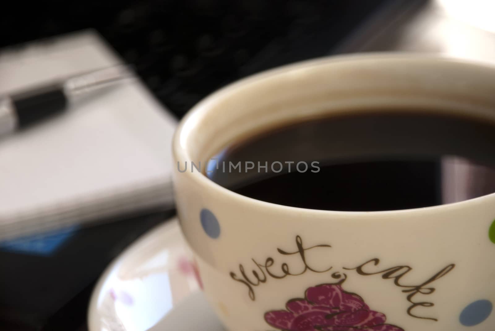 Working desk with laptop,notebook and coffee cup.