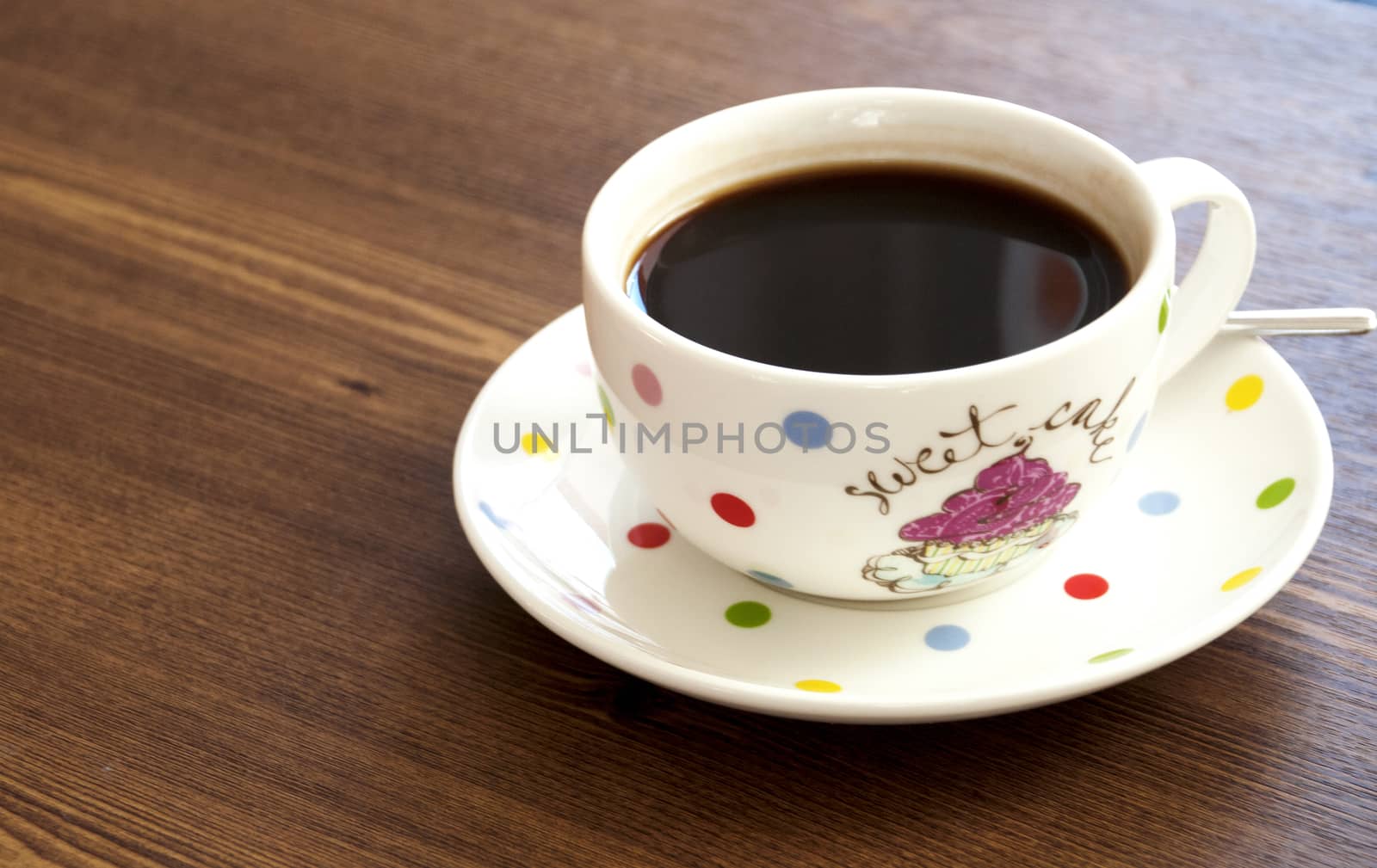 Black coffee cup on old wooden table top view background.