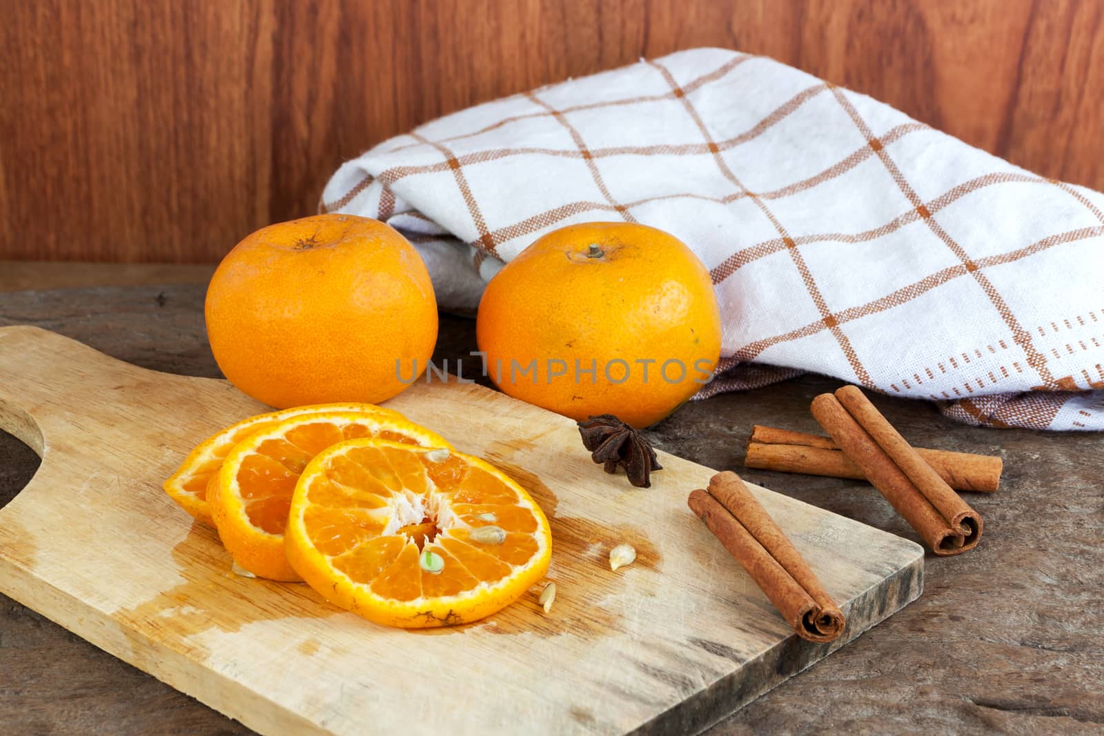 Ripe oranges sliced on oid wood background. Orange in a cut.