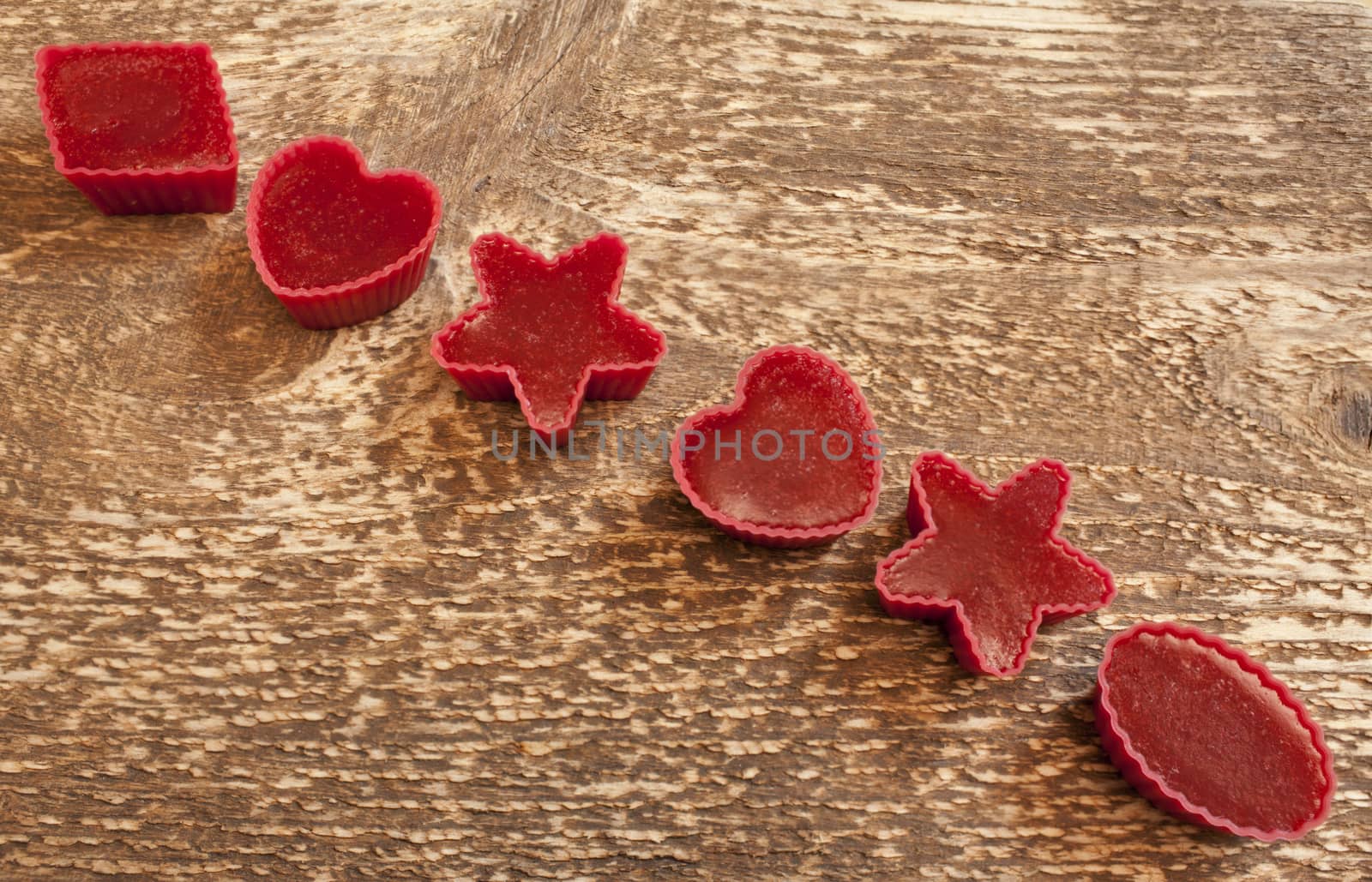 Red marmalade in molds on wooden background by mrivserg