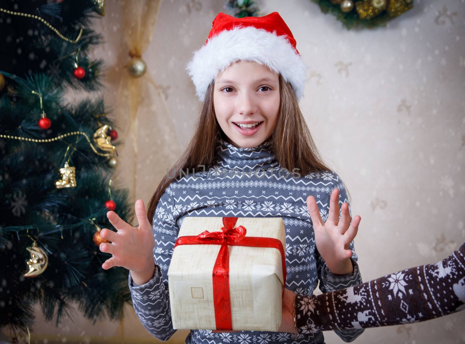 Surprised girl receiving Christmas gift by Angel_a