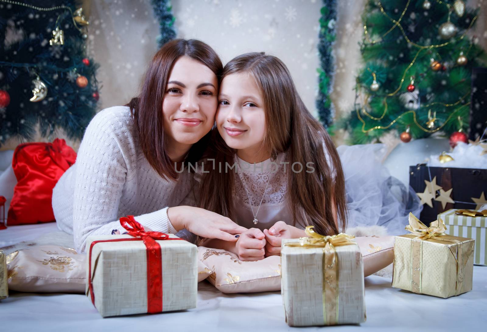 Mother and daughter under Christmas tree by Angel_a