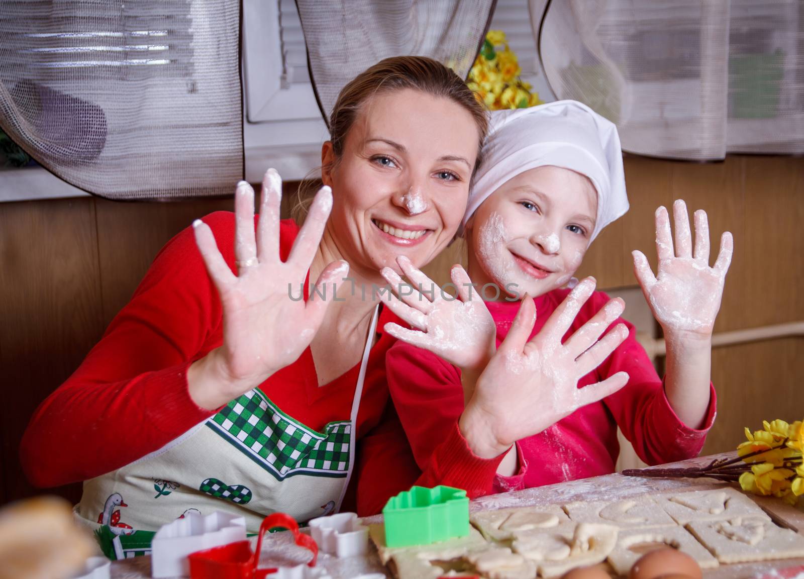 Mother and daughter having fun with flour