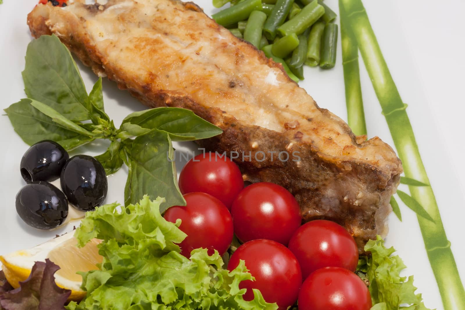 freshly cooked fish and fresh vegetables on the plate