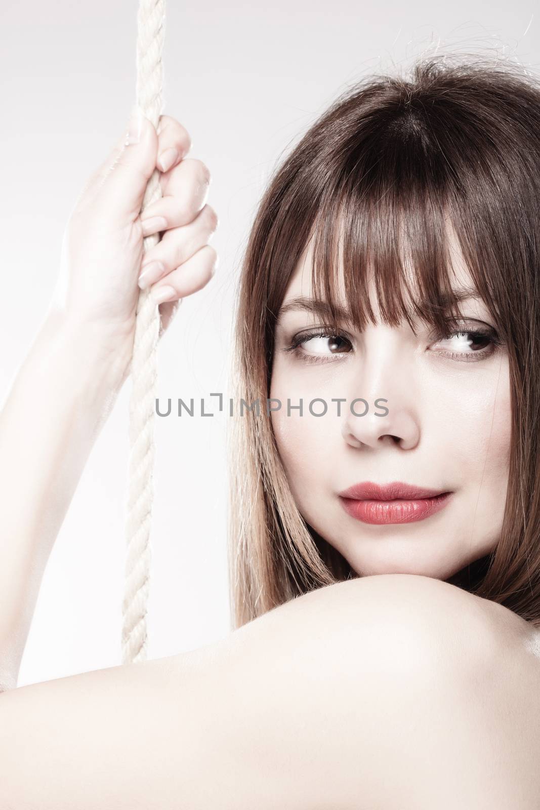 portrait of a beautiful girl holding on a rope