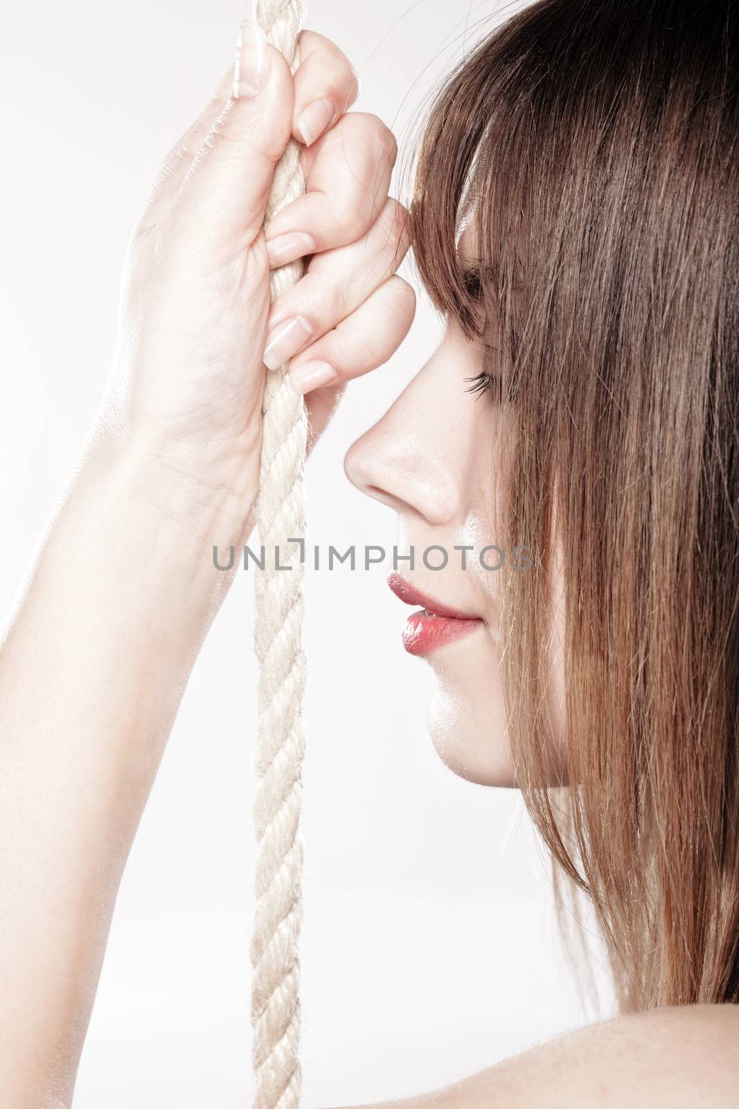 portrait of a beautiful girl holding on a rope