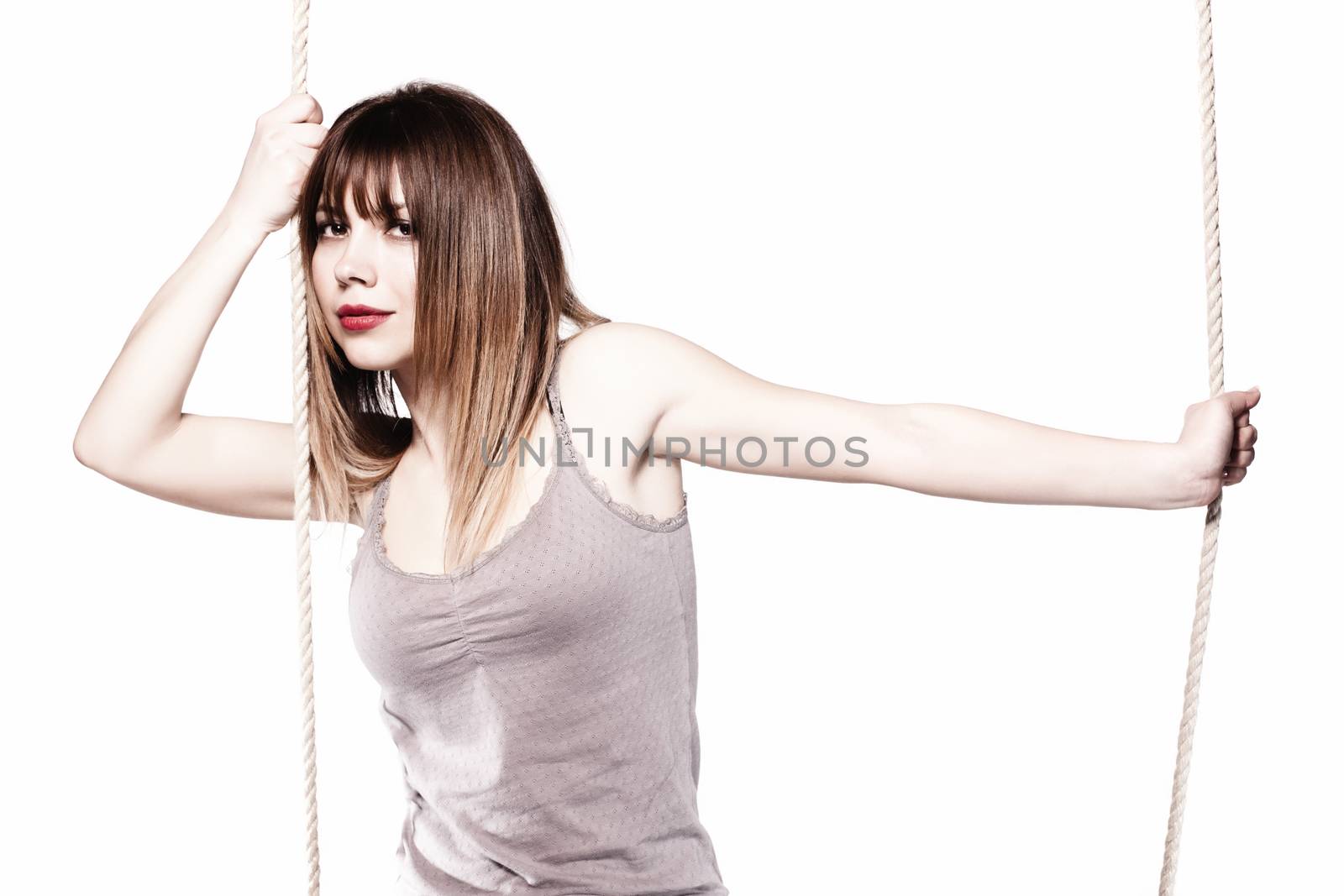 portrait of a beautiful girl holding on a rope