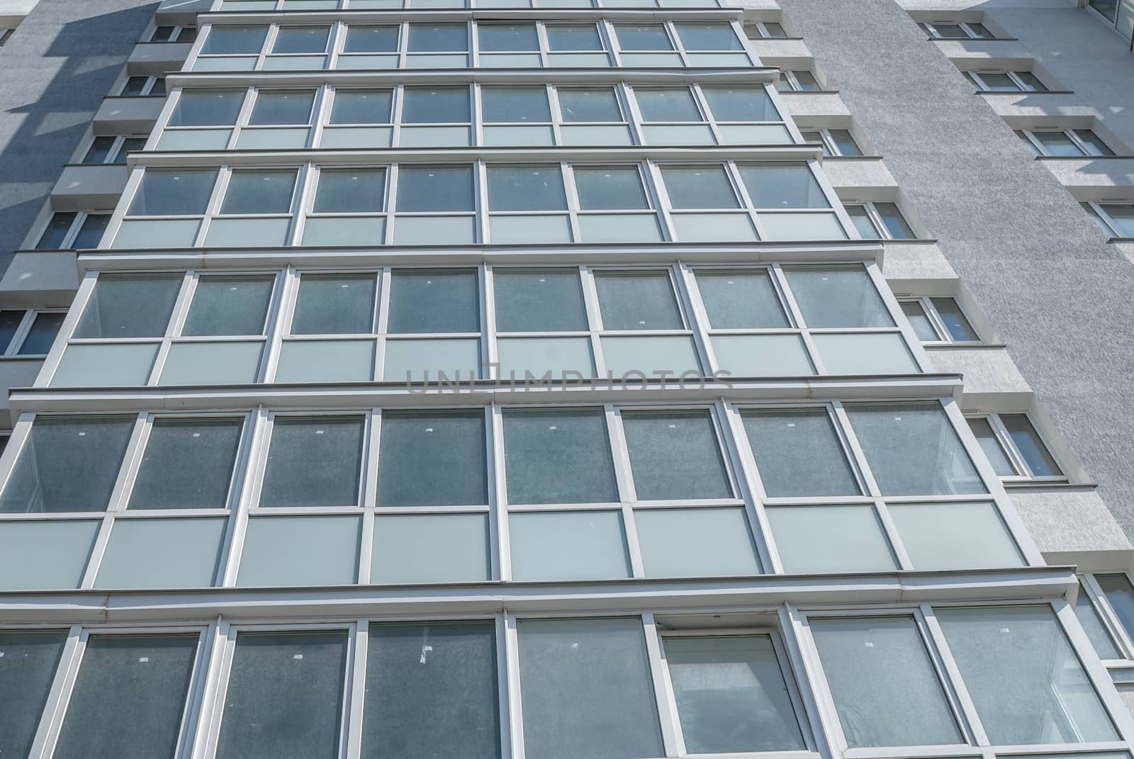 kind of new multistory residential building decorated in grey colors in sunny day