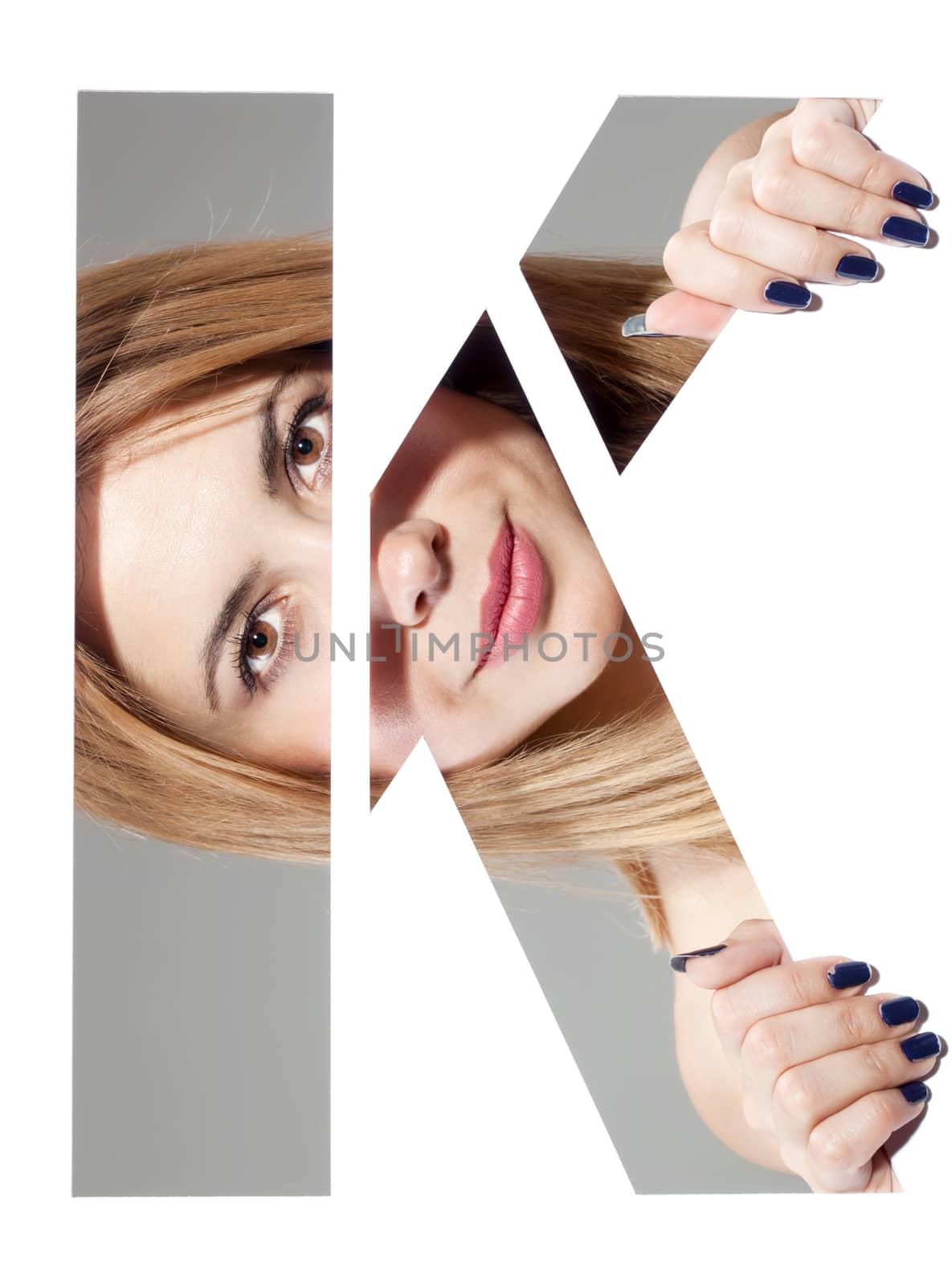 girl hiding behind and holding the letter "K"