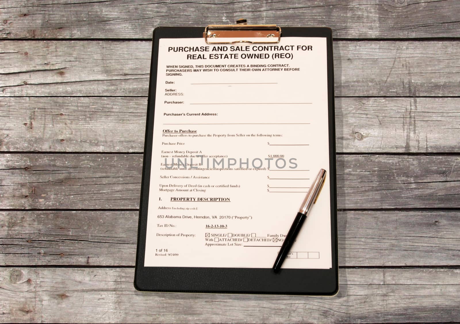 Form of contract with a black pen on a wooden table made of grey Board