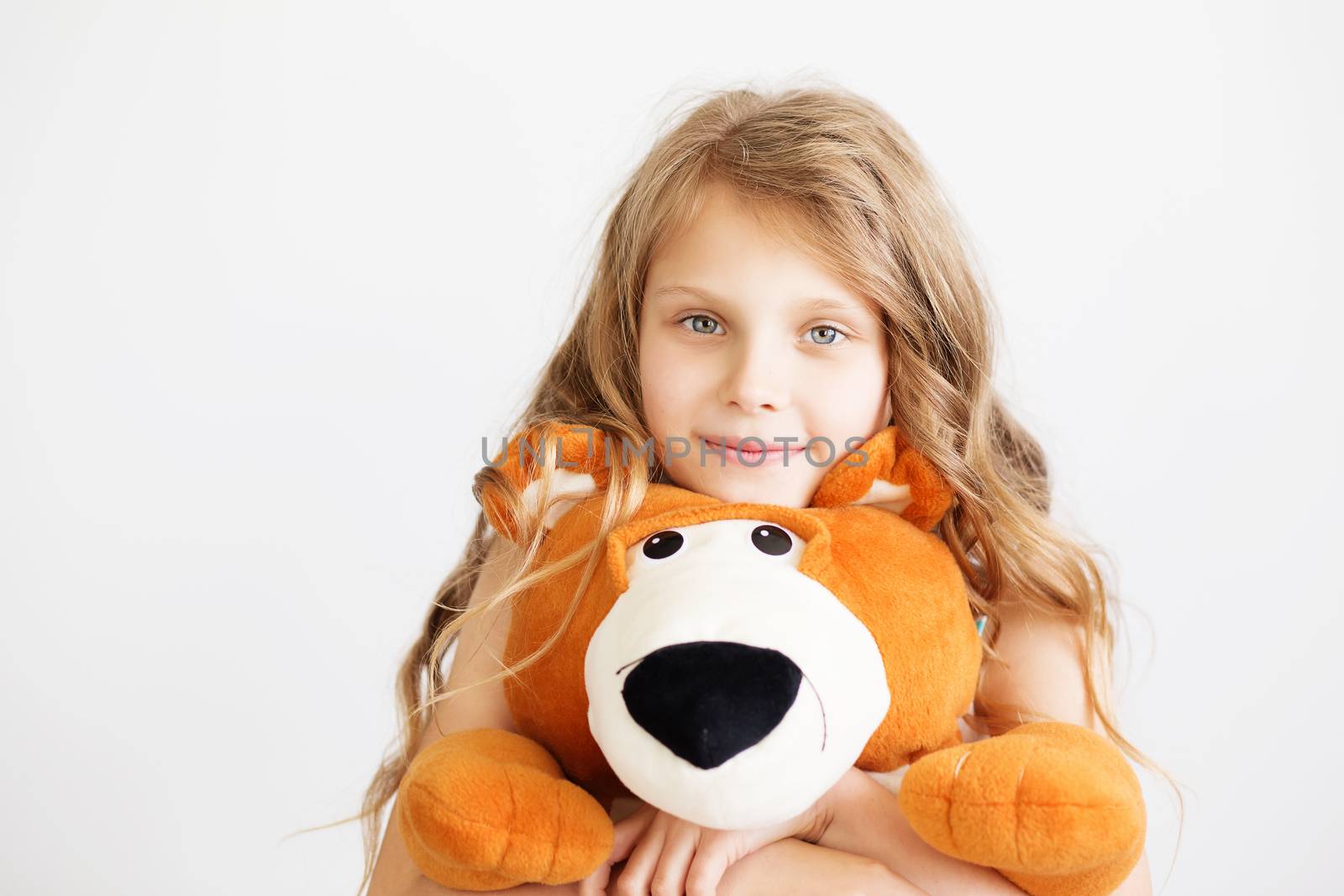 Little girl with big teddy bear having fun laughing Isolated on white background
