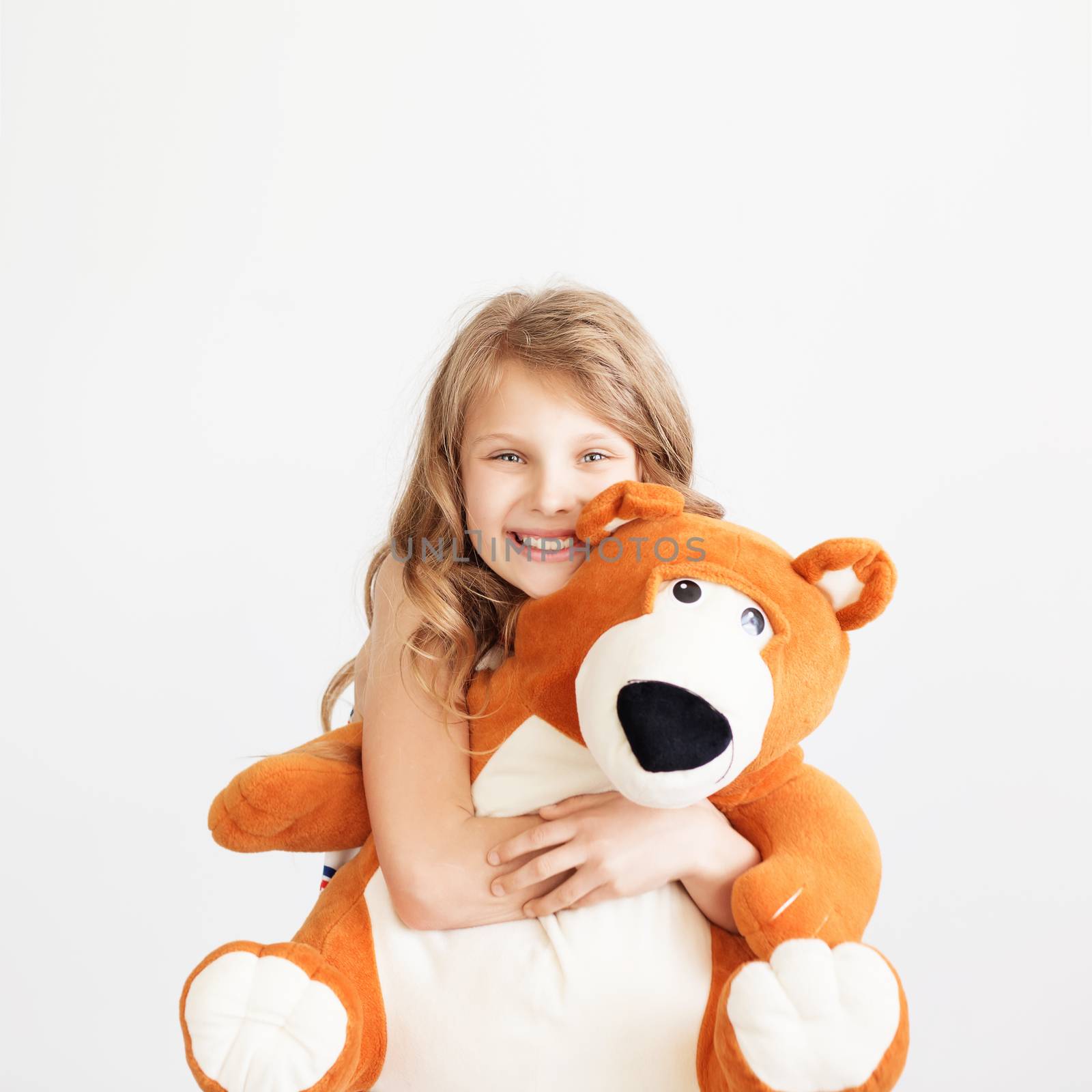Little girl with big teddy bear having fun laughing Isolated on by natazhekova