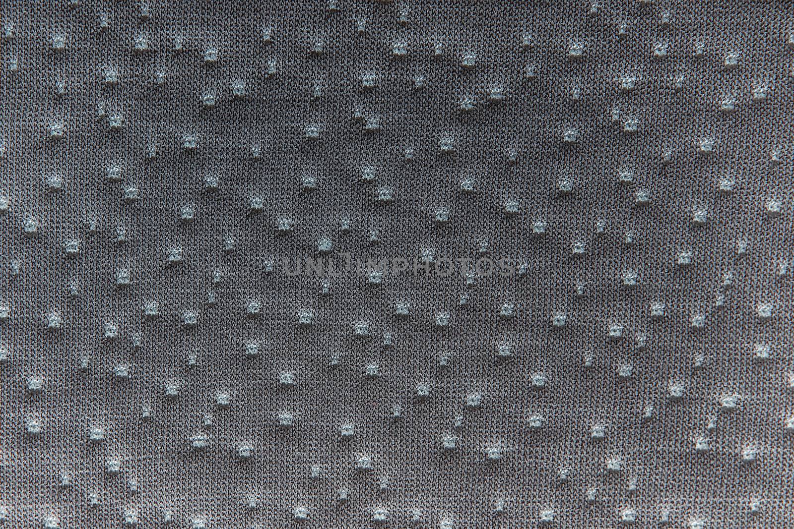Gray fabric dotted texture. Clothes background. Close up