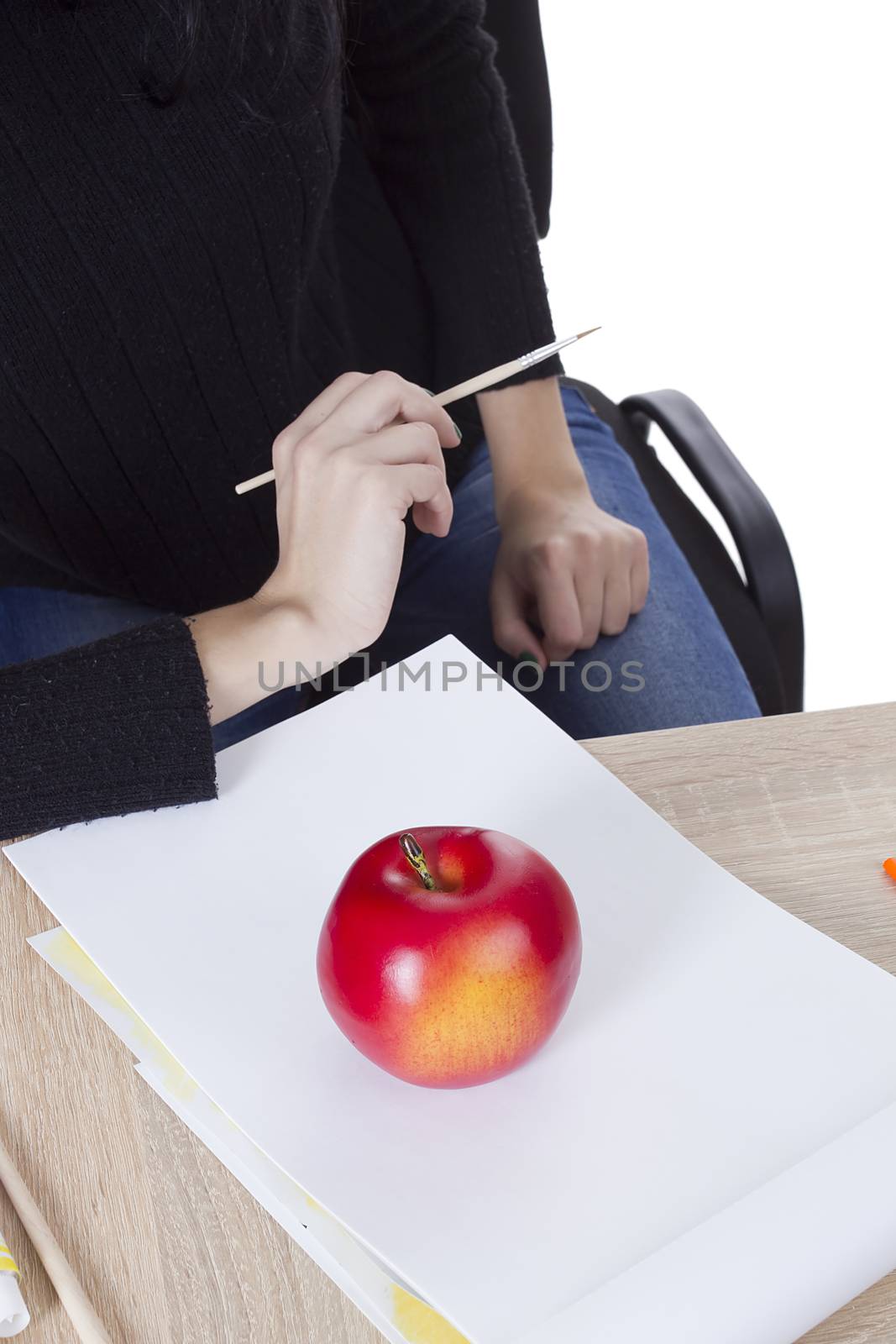Artist is going to draw an apple on a wooden background