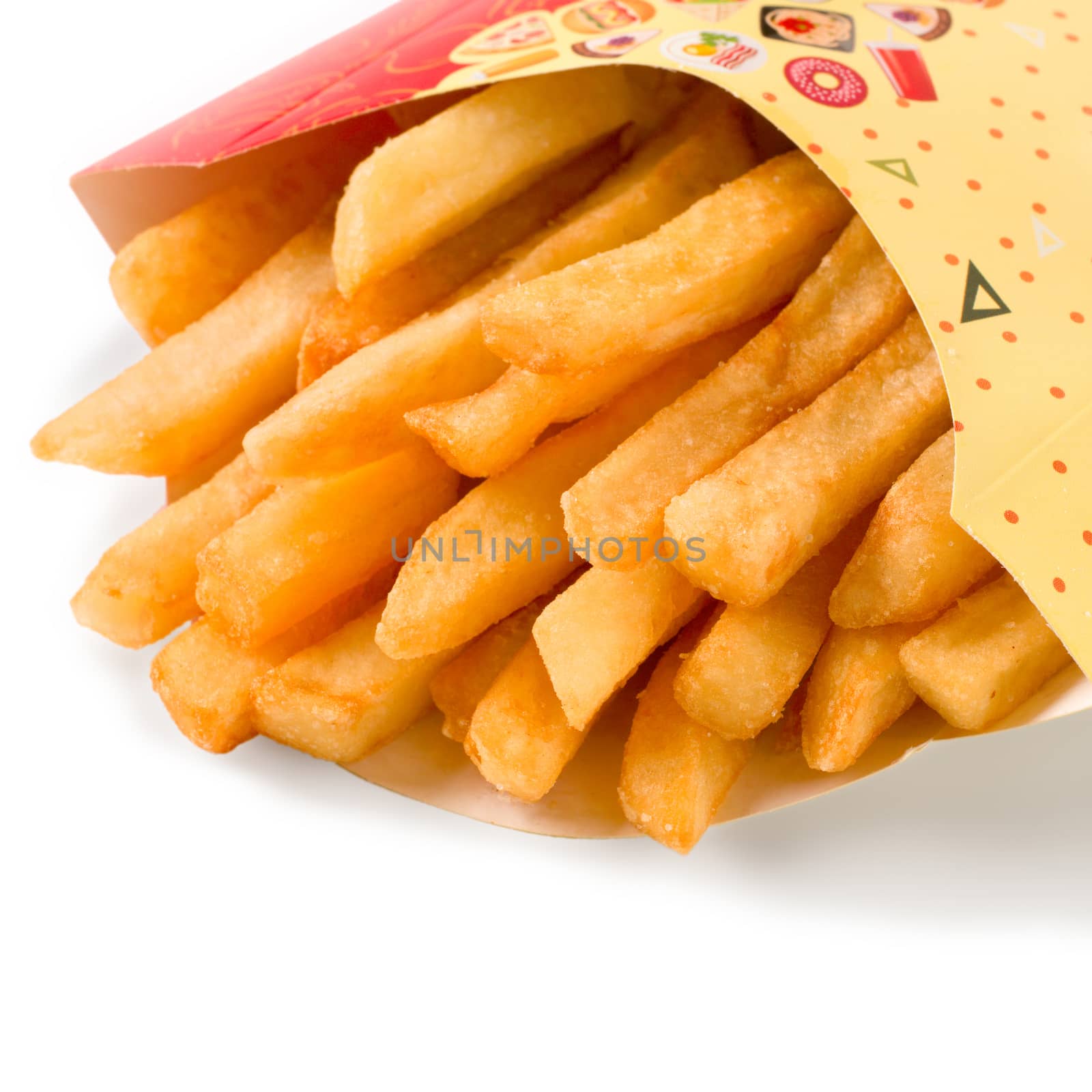 close up view of french fries in colorful cartoon box. Isolated on white with clipping path. Copy space.