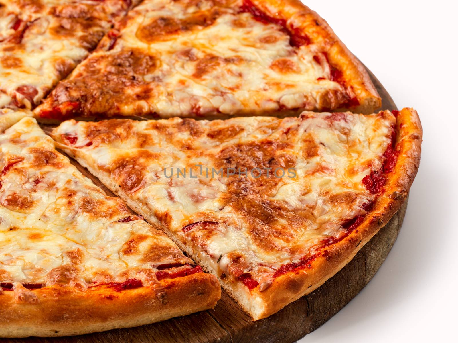 Close up view on piece of pizza with 4 sorts of cheese on wooden cutting board. Isolated on white with clipping path