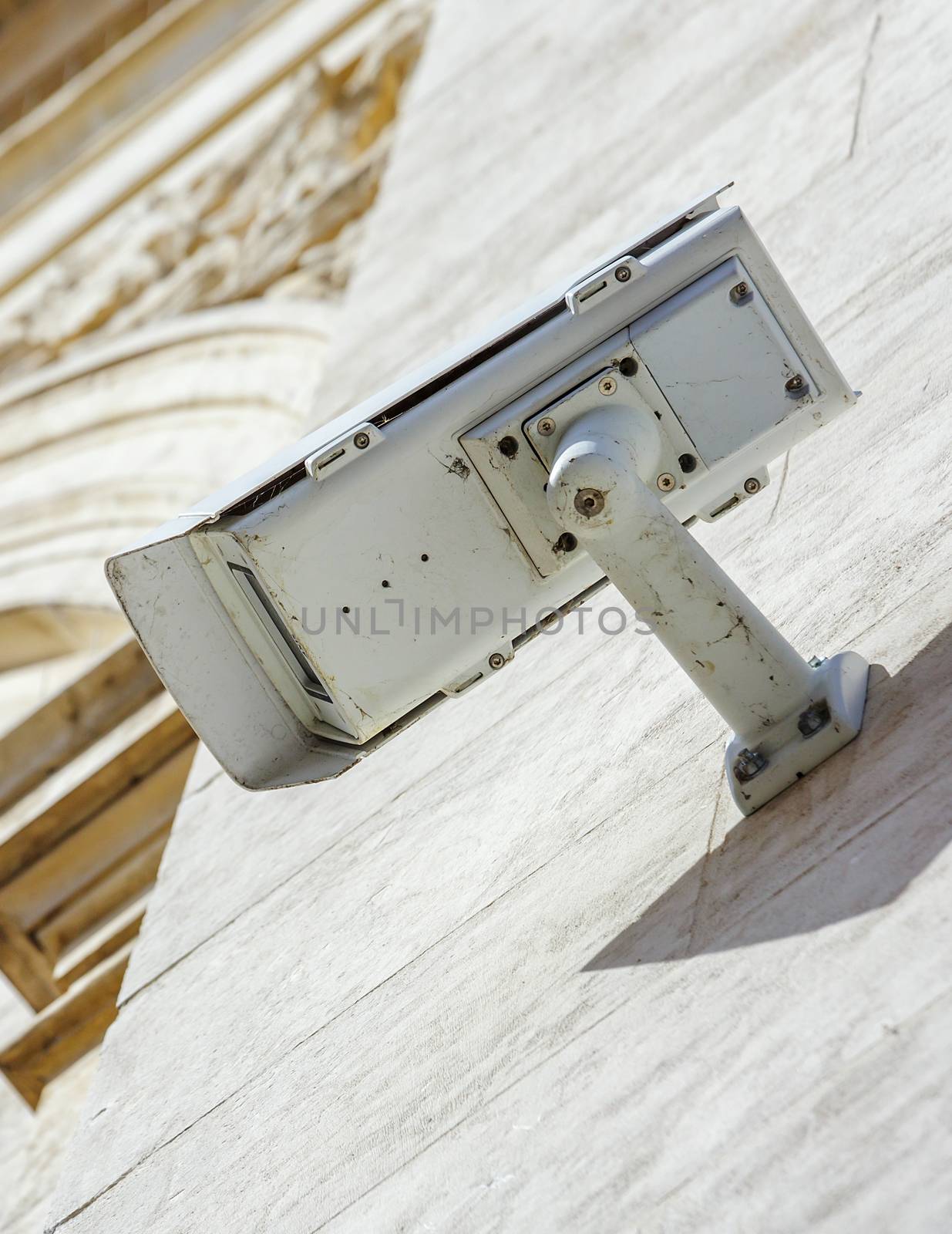 security CCTV camera or surveillance system fixed on old construction wall