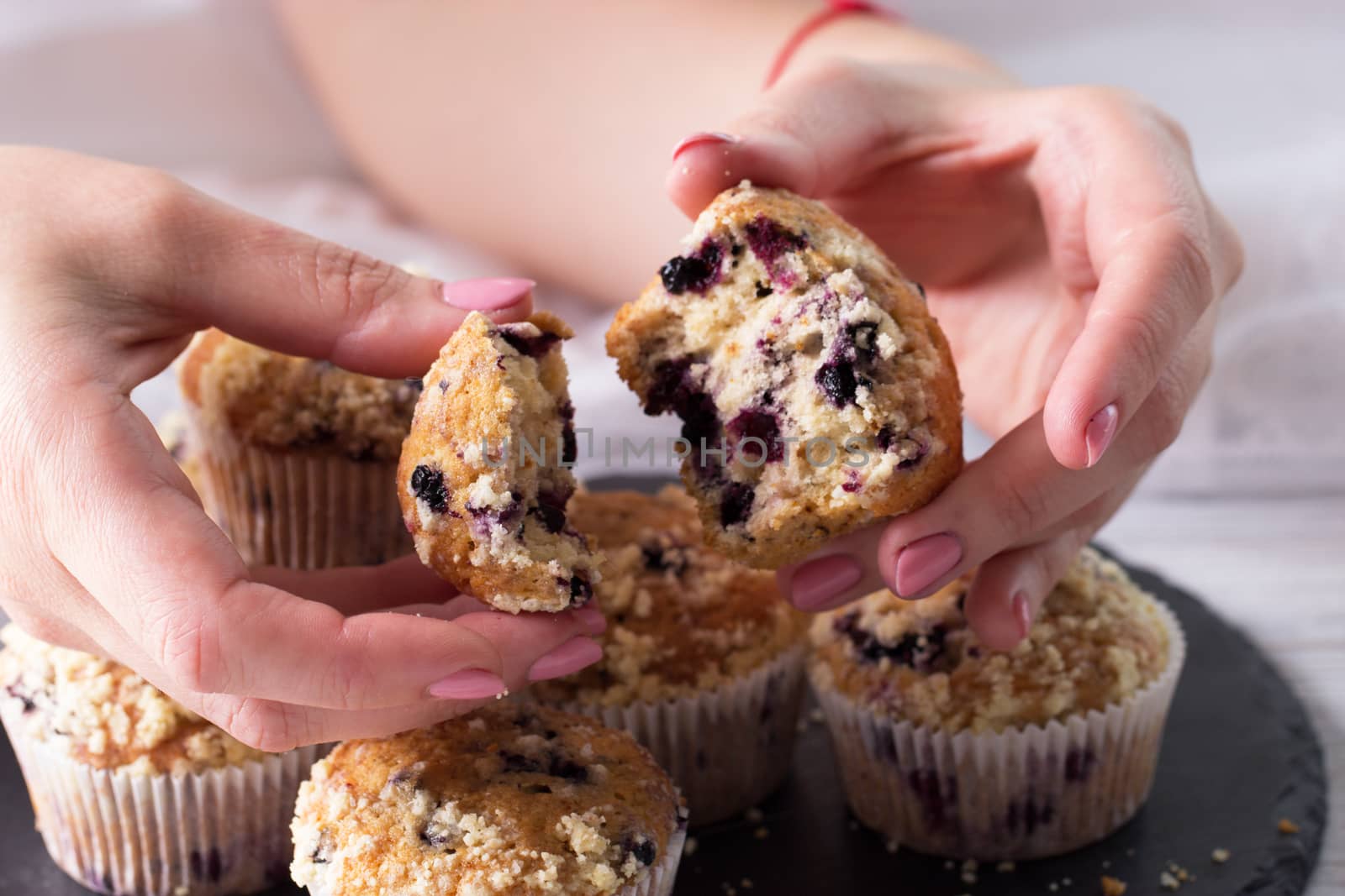 Closeup female hands  and cup cake with fresh berries. Blueberry muffins with fresh berries. homemade blackberry muffins 