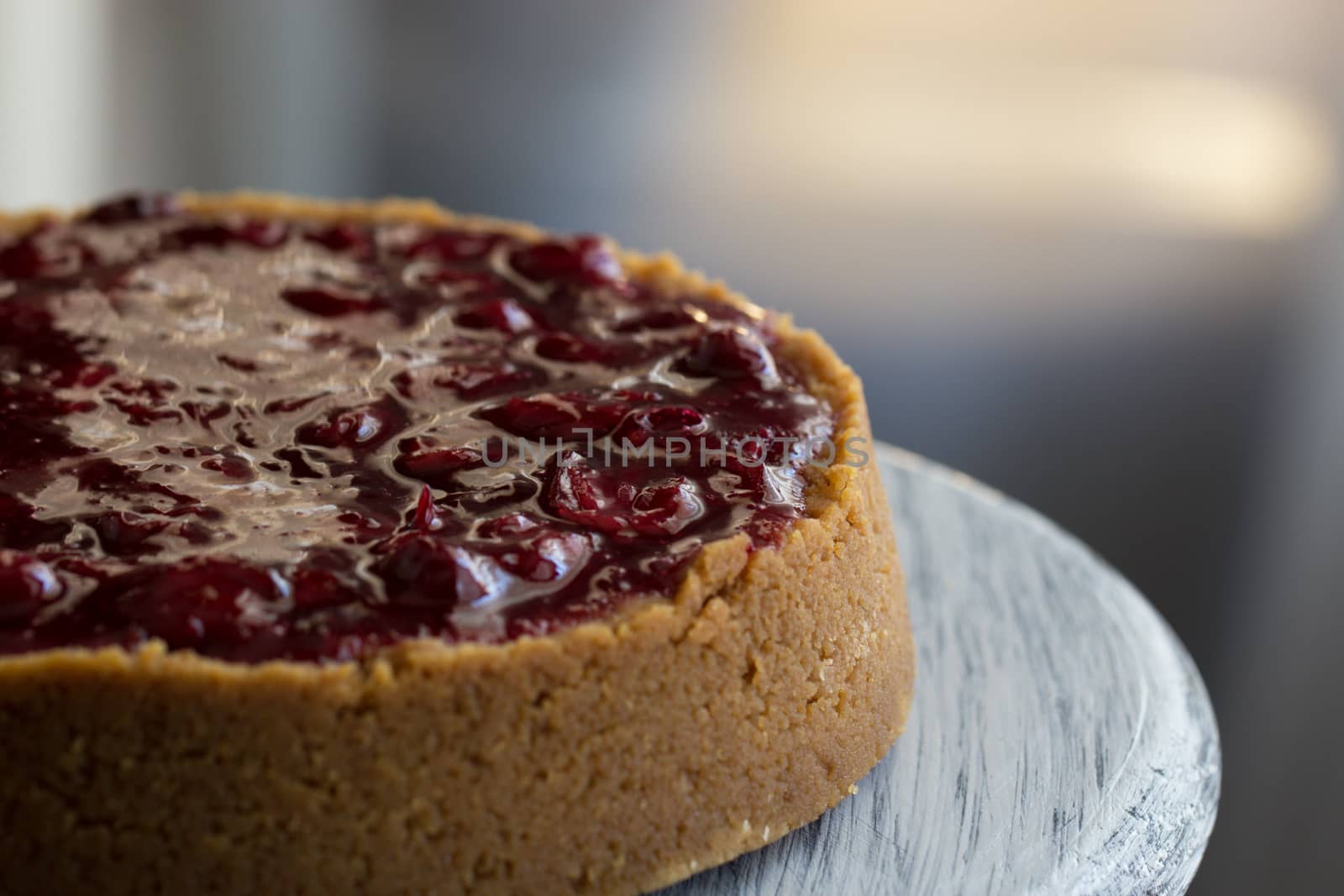 Cheesecake decorated with cherry sauce with berries