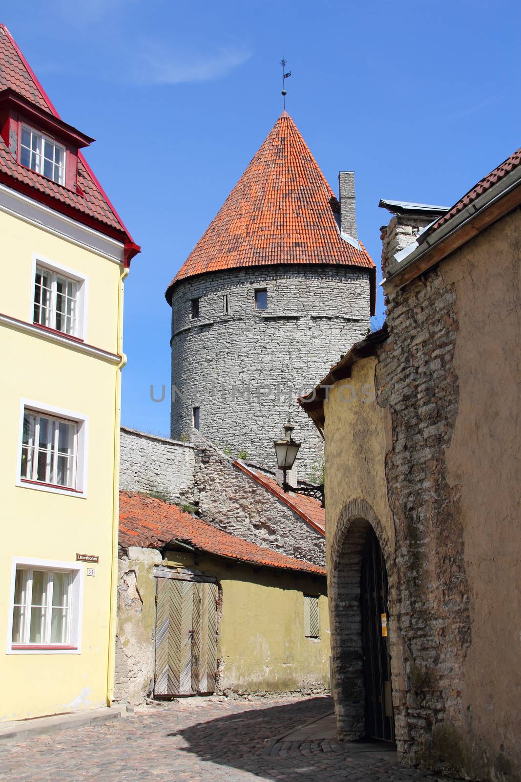 Colorful street and old castle tower in the Old Town of Tallinn, Estonia