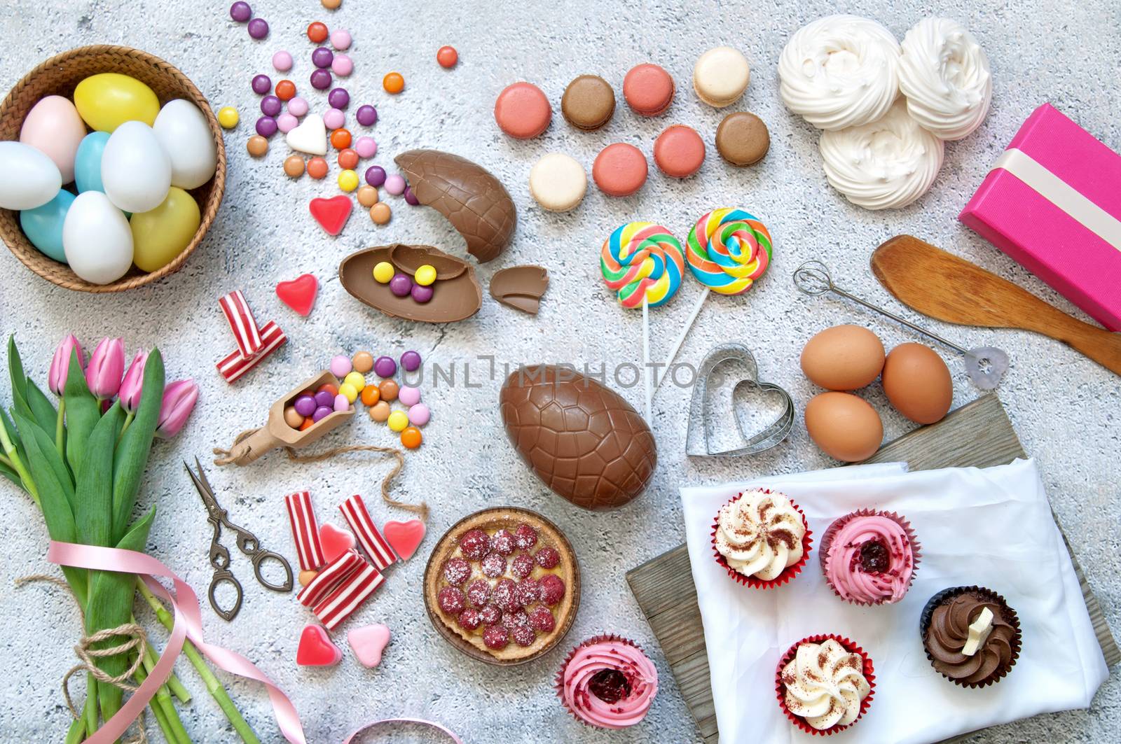 Selection of easter sweets, bakery cupcakes, chocolate eggs and confectionery