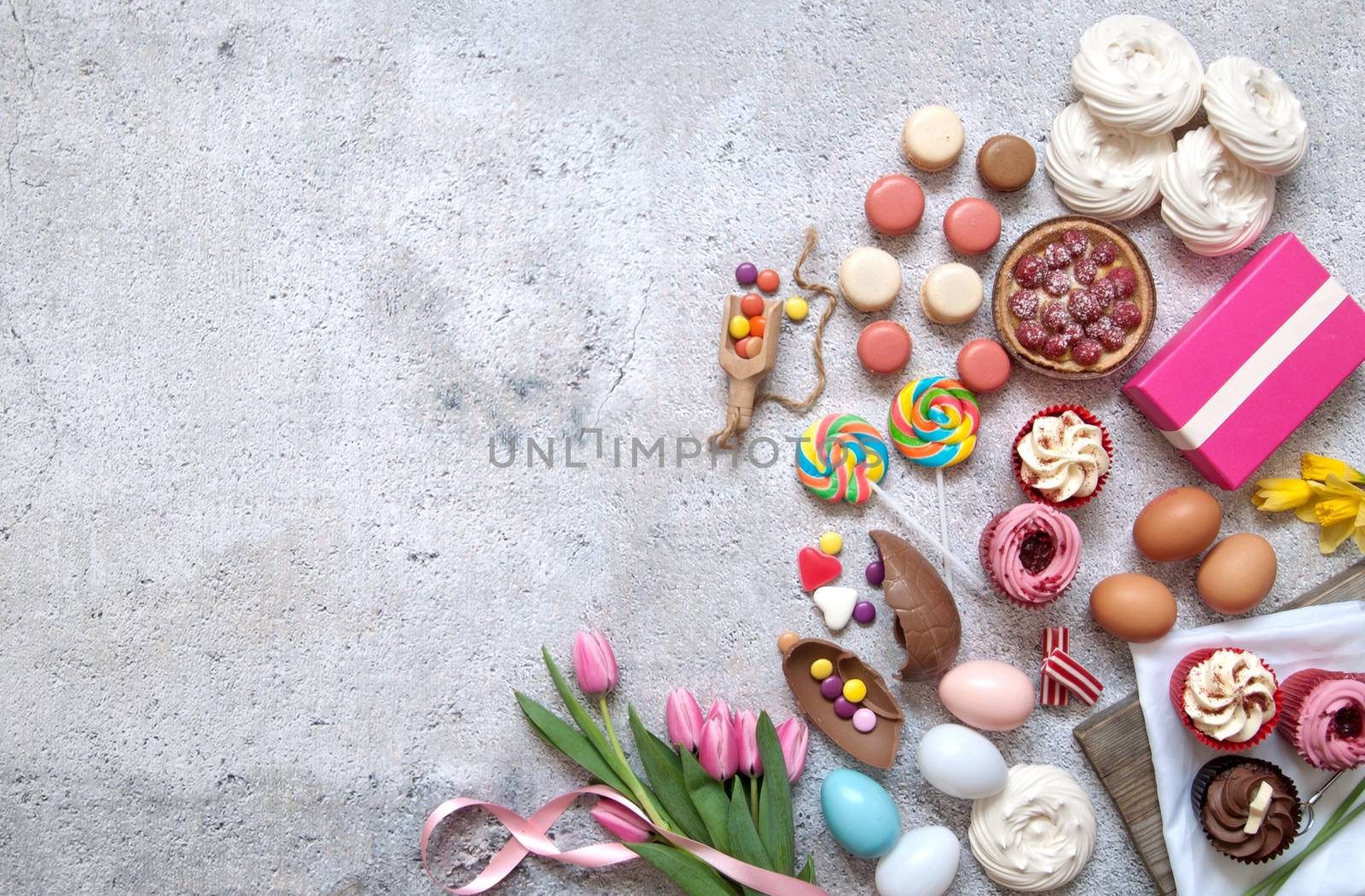 Assorted easter sweets, bakery cupcakes, chocolate eggs and confectionery with space 