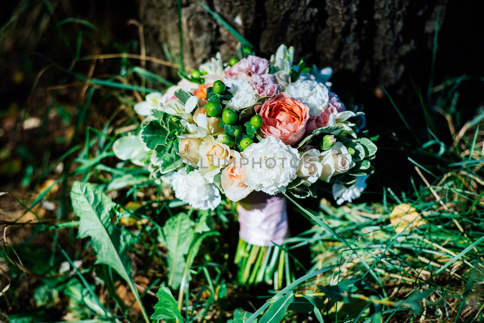 Lush wedding bouquet under the tree