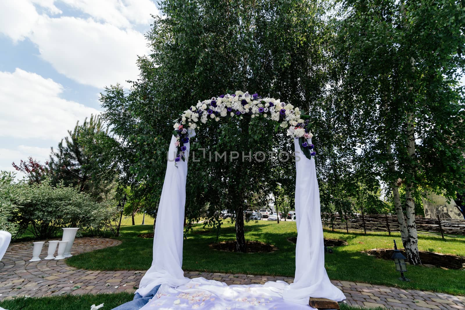 Wedding arch with flowers and white cloth near the birch by d_duda
