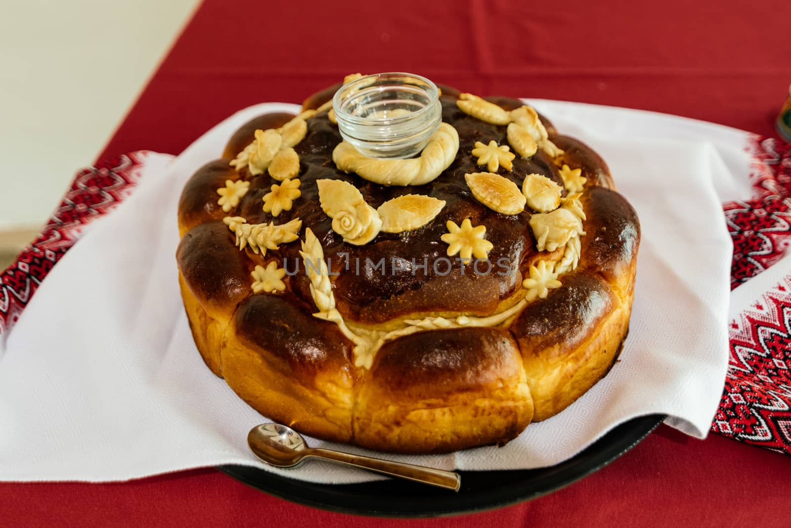 Wedding loaf with salt on white embroidered towel
