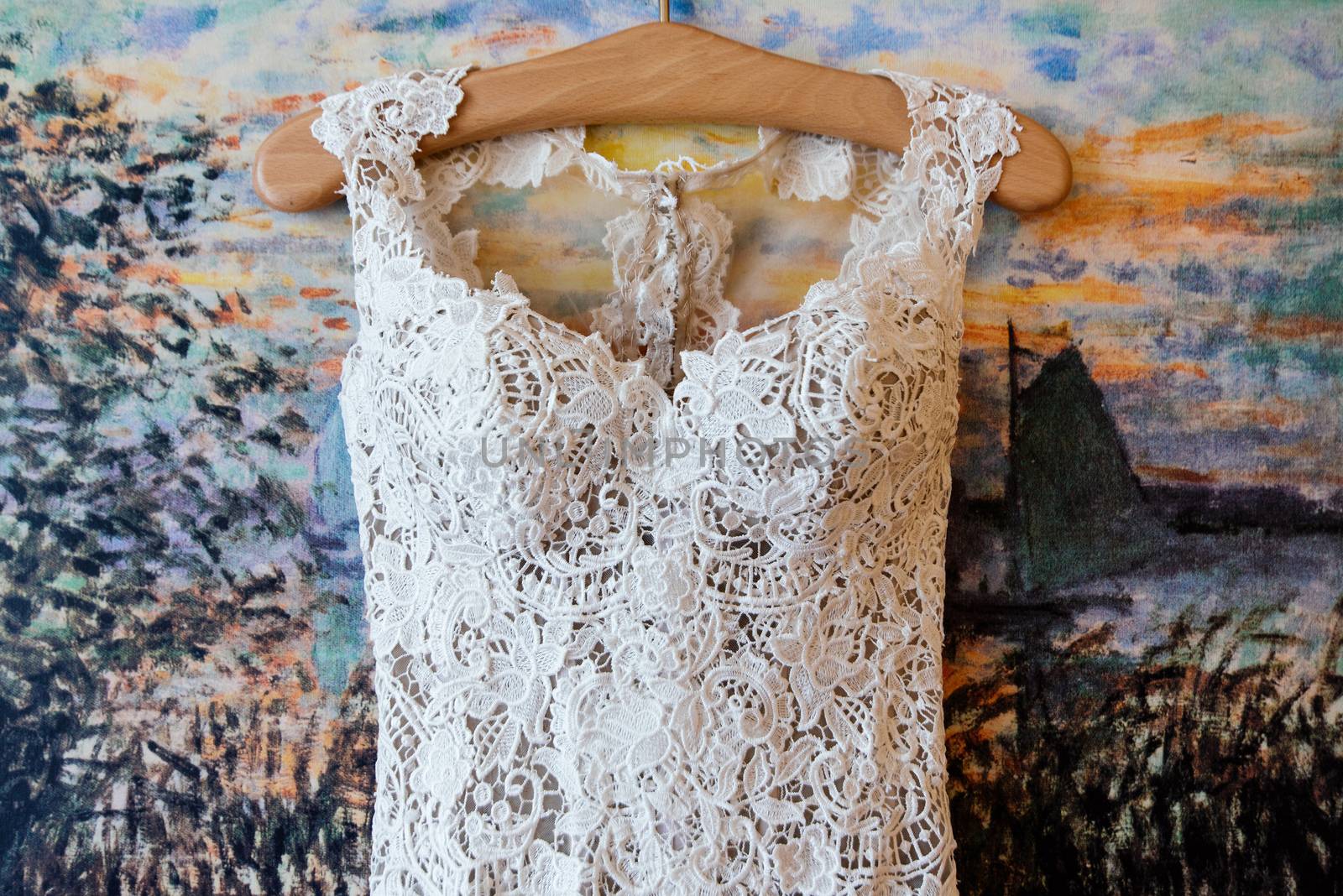 Lace top wedding dress hanging on the wall by d_duda