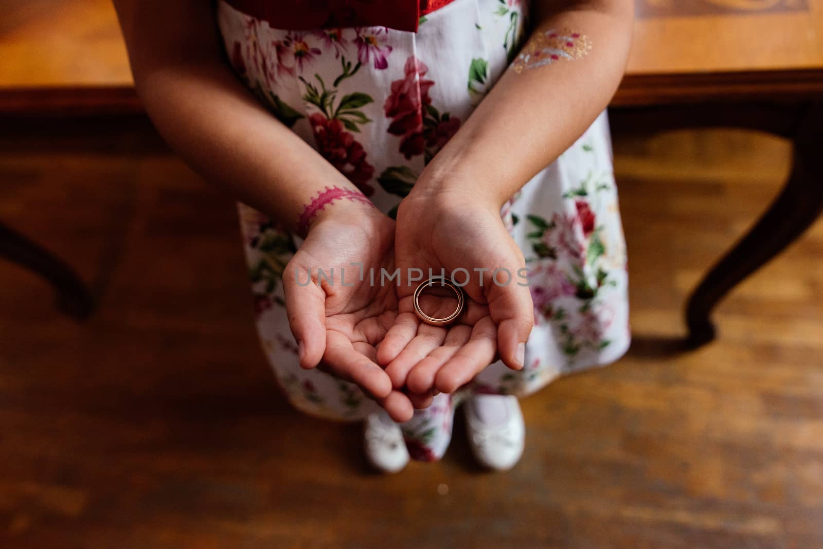 Two golden wedding rings in the girl's hands 