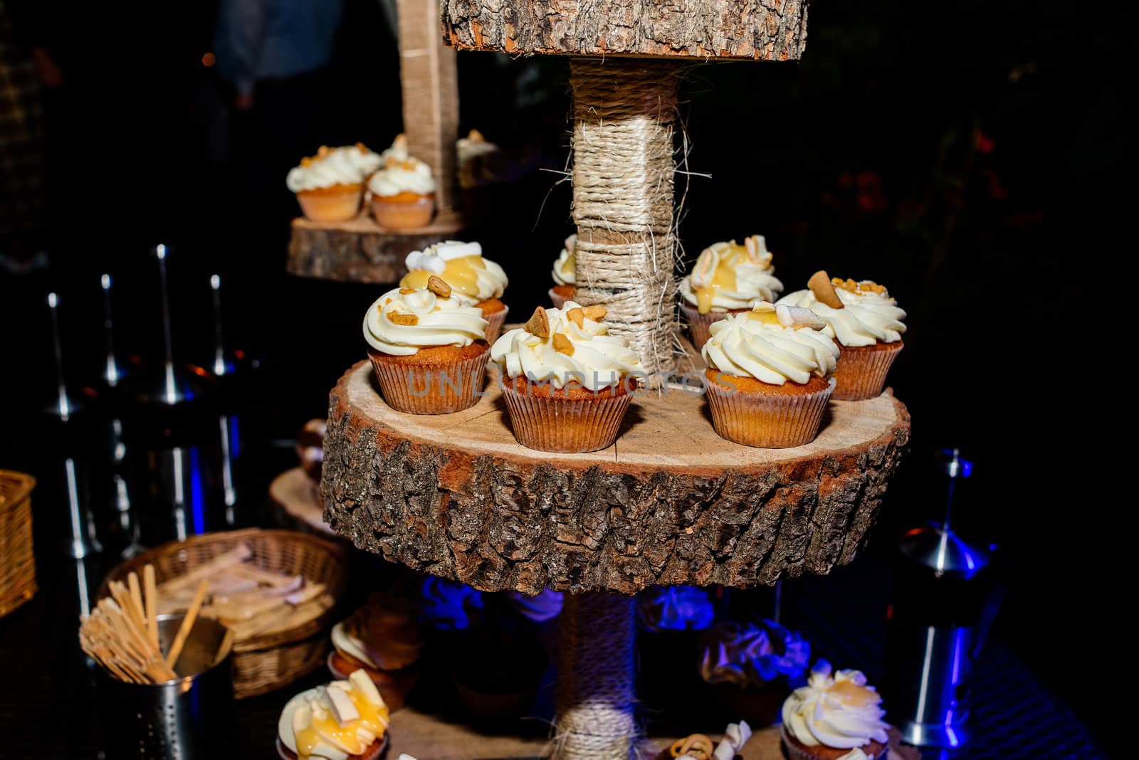 Holiday candy bar. Candy bar served with cupcakes with cream and biscuits on wooden stump