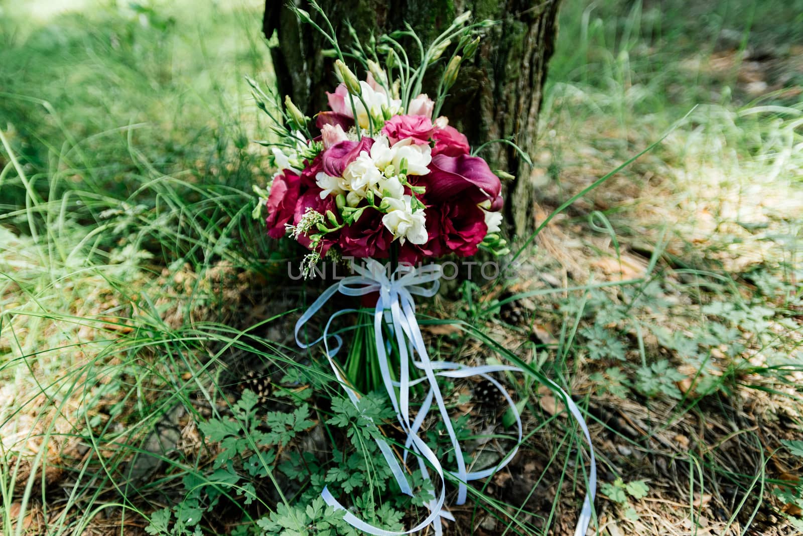 Lush wedding bouquet of white and vinous flowers under the tree by d_duda