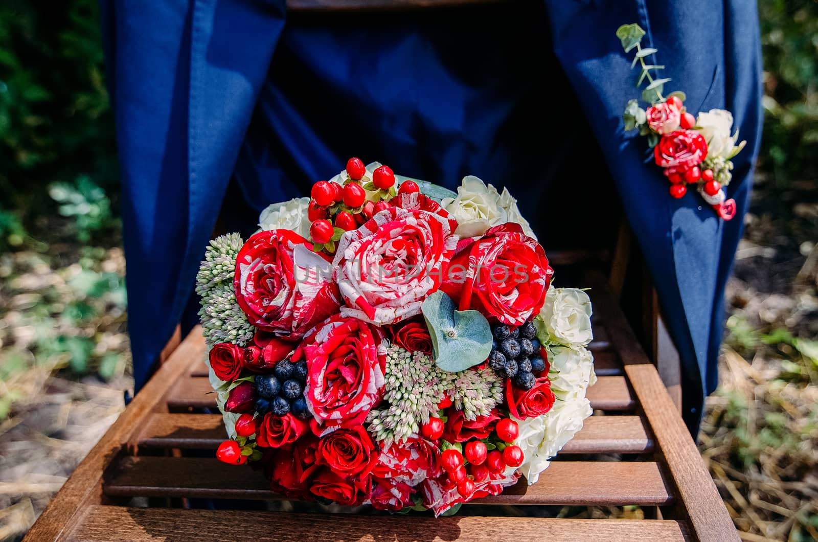 Wedding bouquet on a wooden chair with a jacket