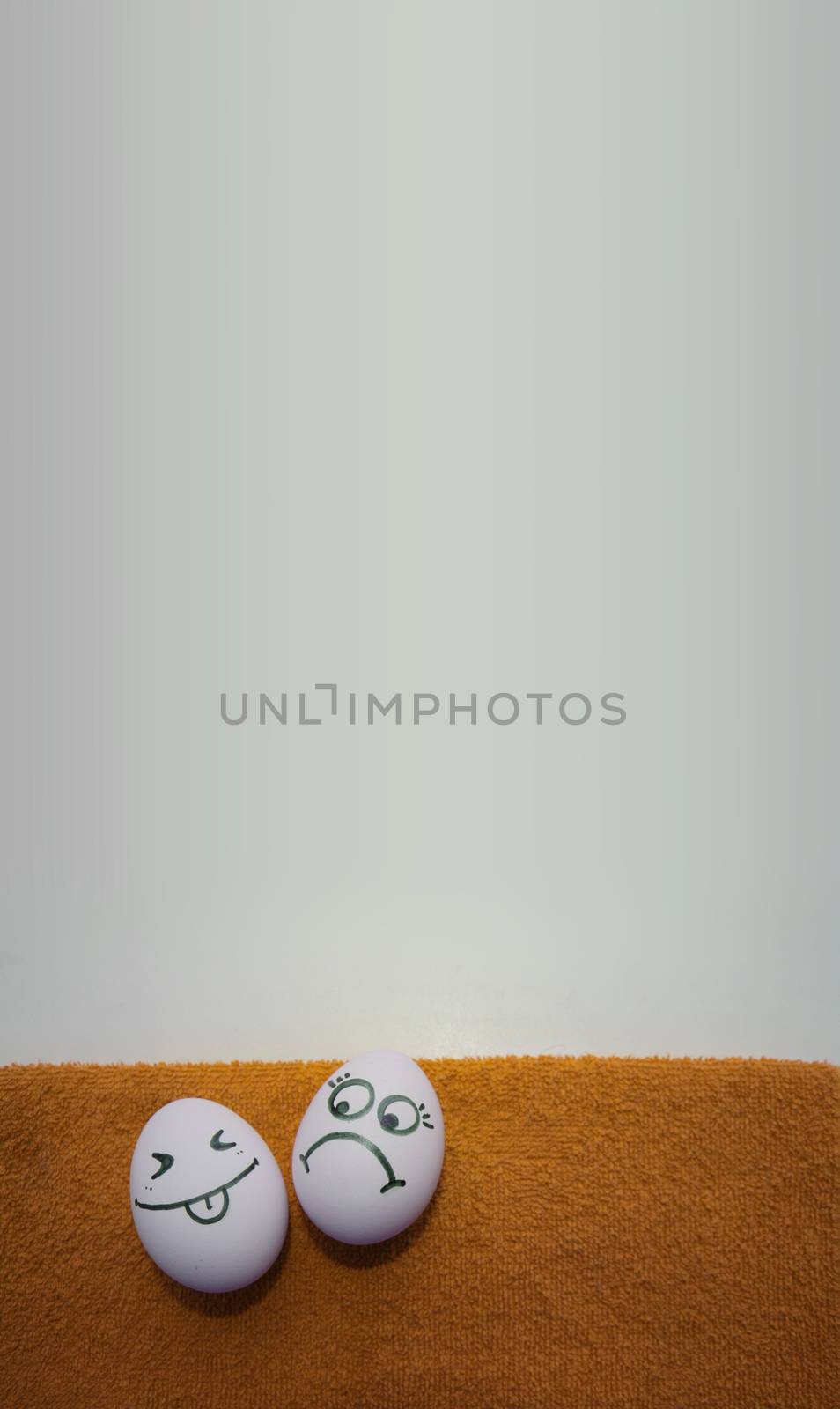 Eggs with faces photo for your design. With a place under the text. Funny and cute. Two bullies and not happy