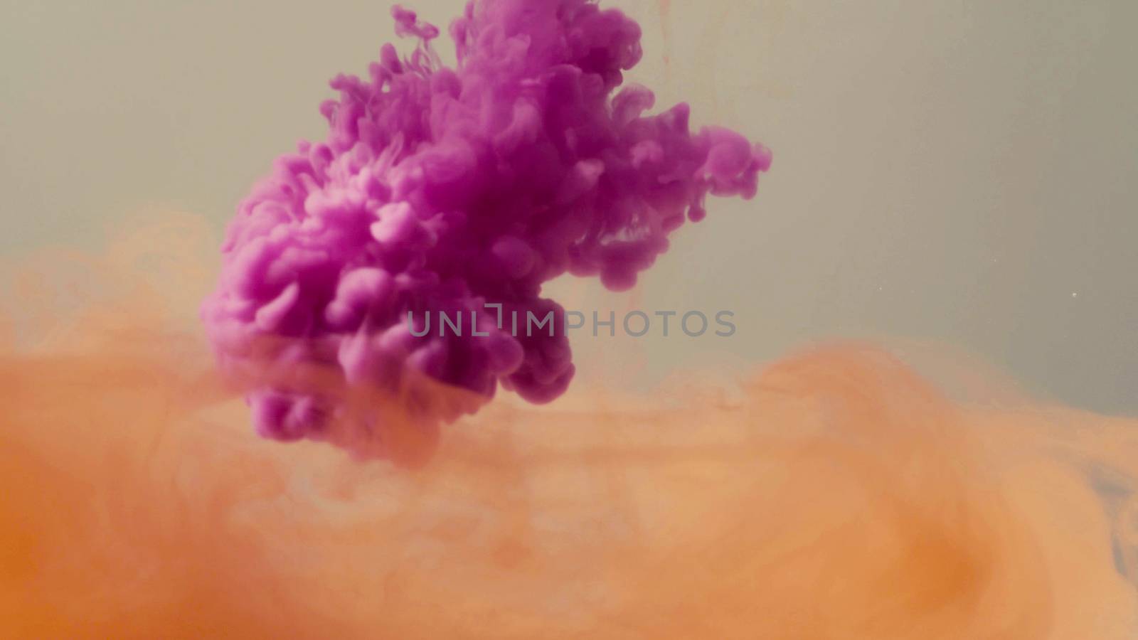 Close up of two colors of ink dropped into the water