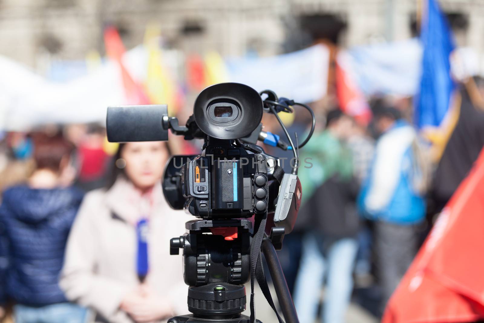 Filming street protest using a video camera by wellphoto