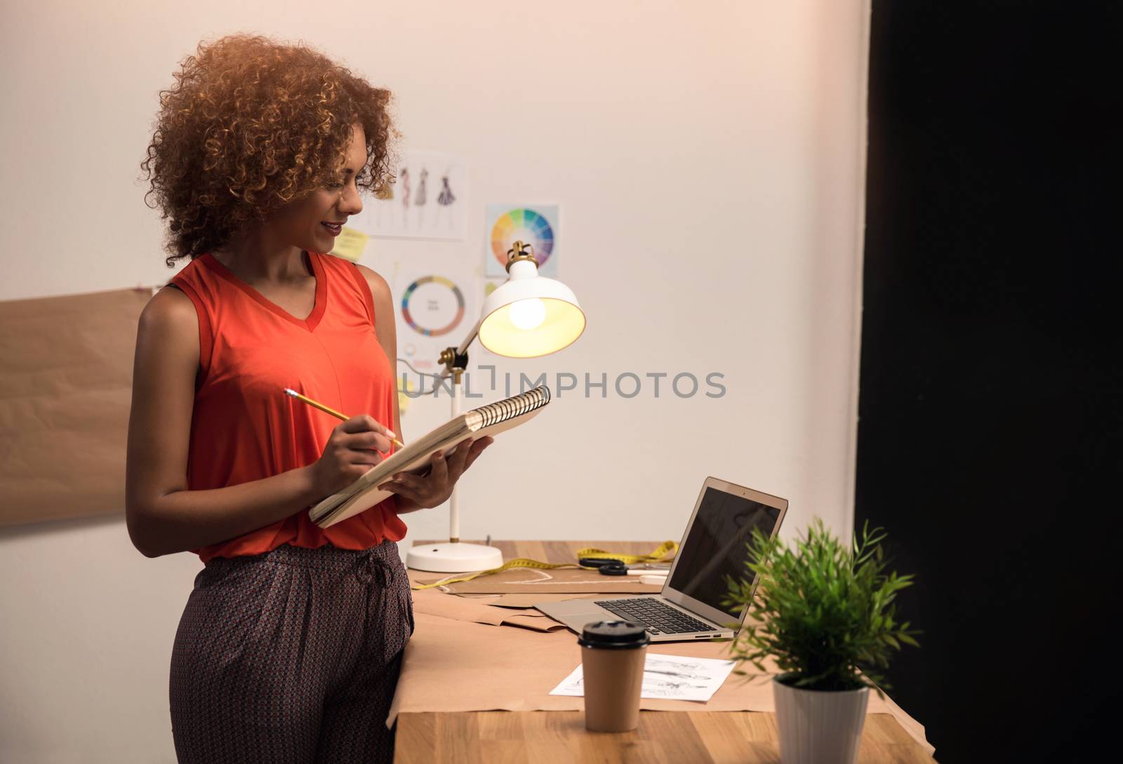 A young fashion designer working on her atelier