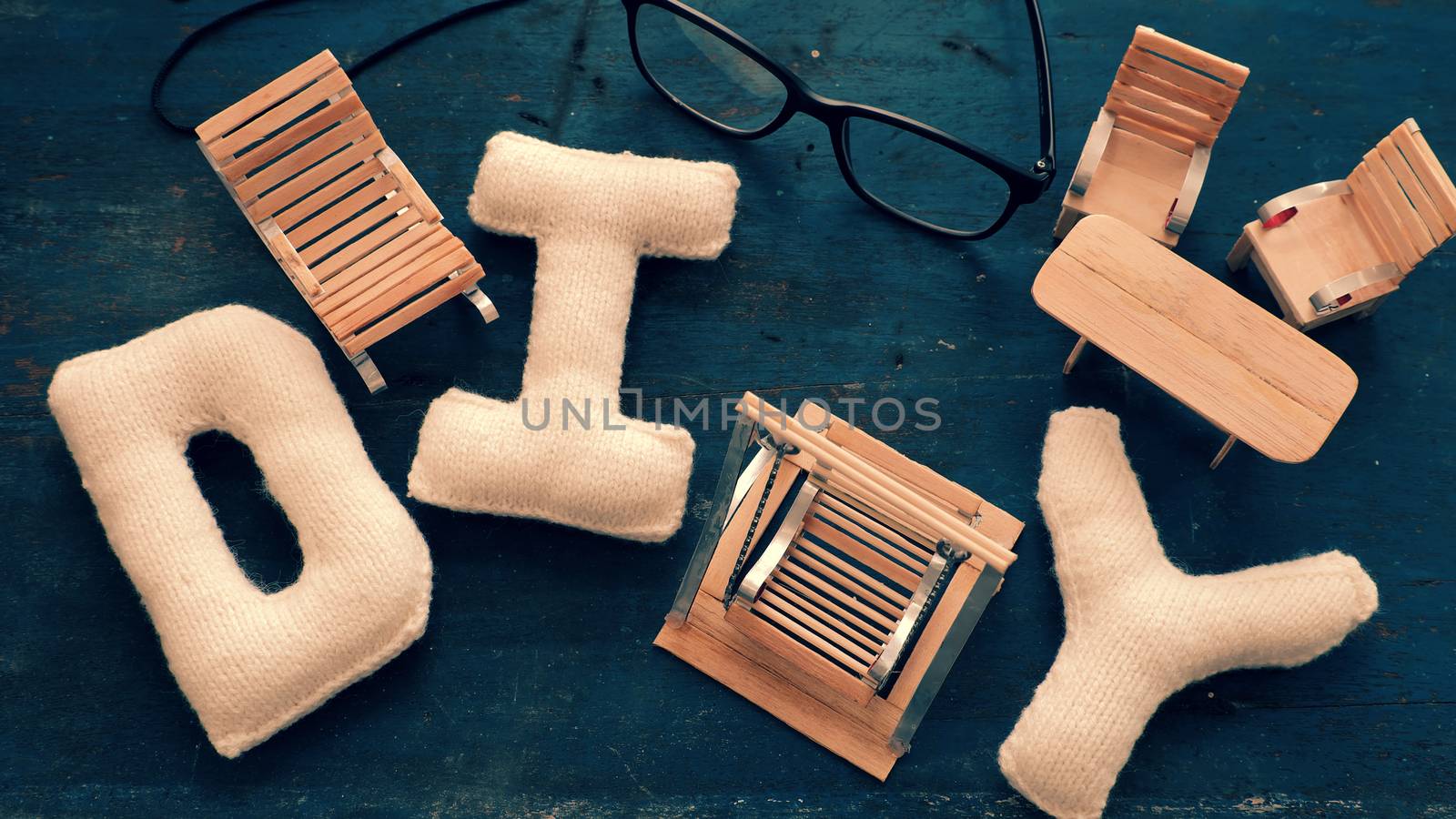 Amazing miniature handmade product for interior design, mini furniture make from wood stick on wooden background, small swing, chair so cute and diy knitted alphabet 