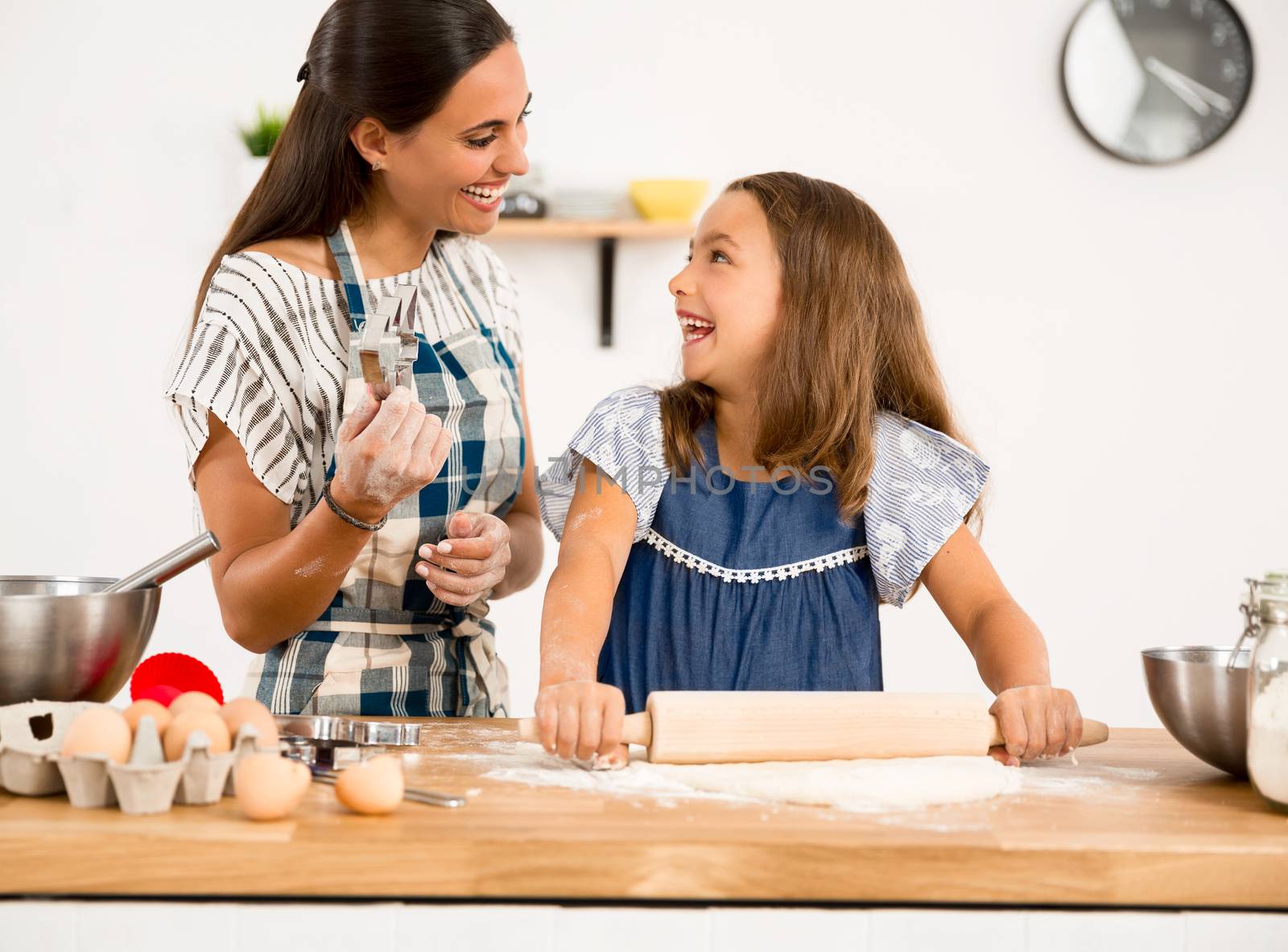 Shot of a mother and daughter having fun in the kitchen and learning to make a cake