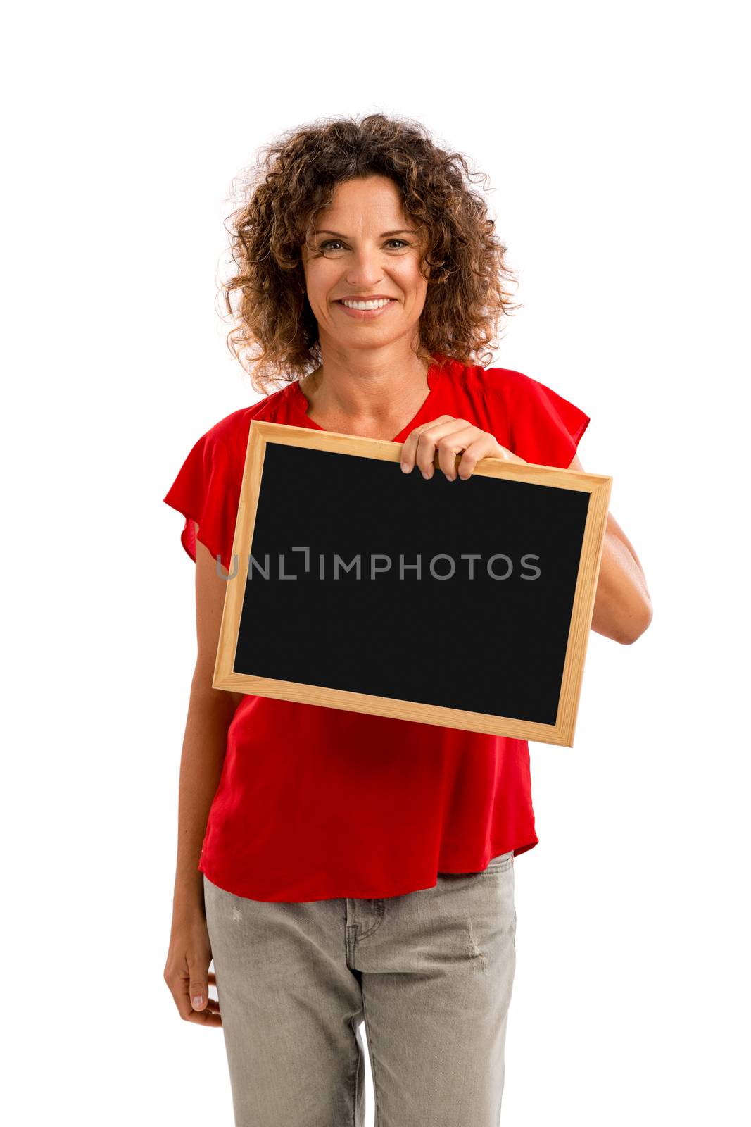 Portrait of a smiling middle aged brunette holding a chalkboard