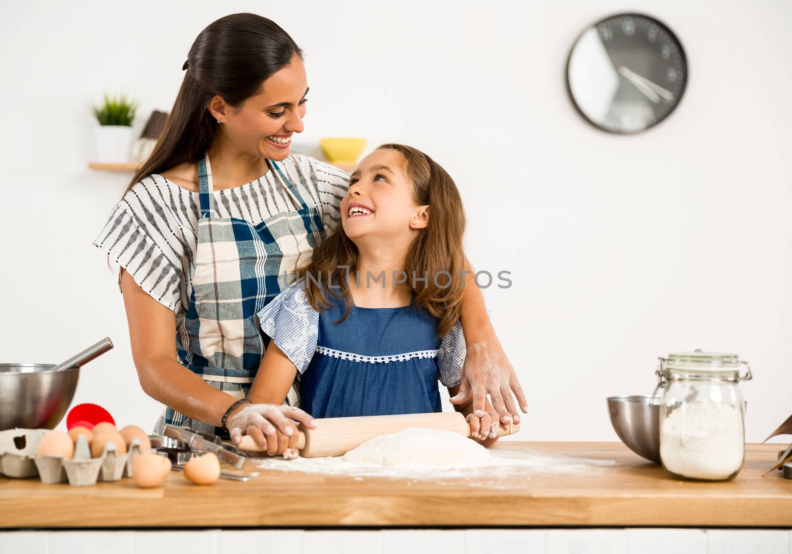 Shot of a mother and daughter having fun in the kitchen and learning to make a cake