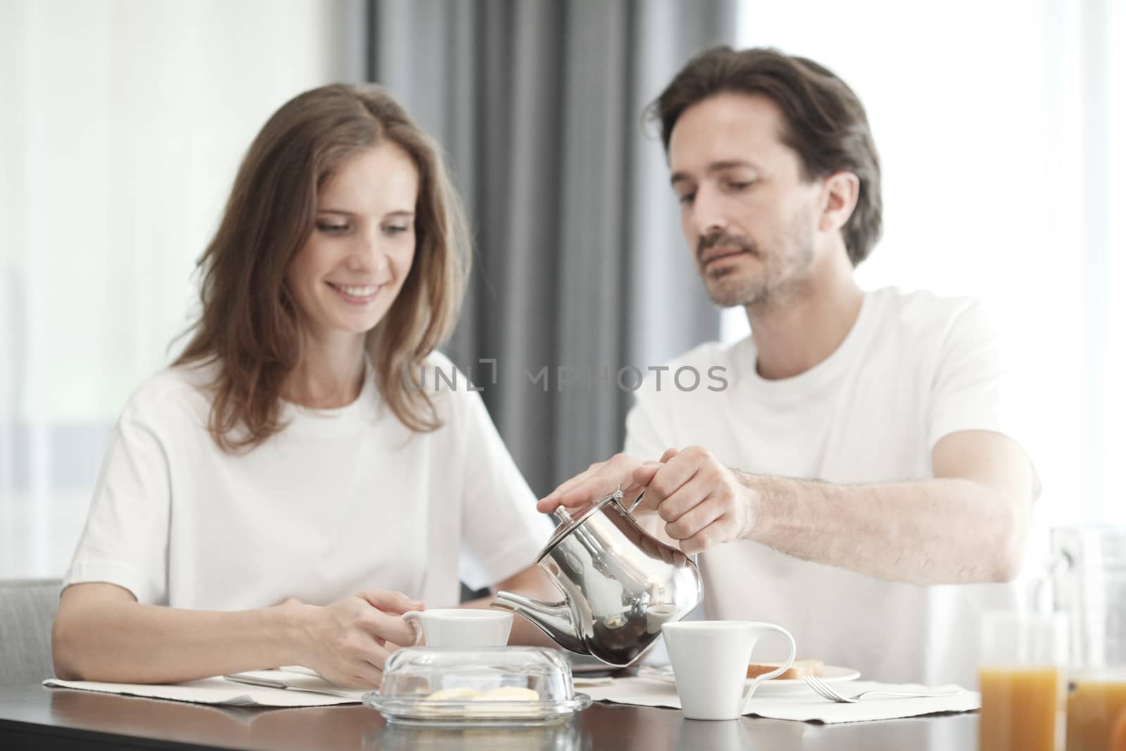 Couple having breakfast together at home 