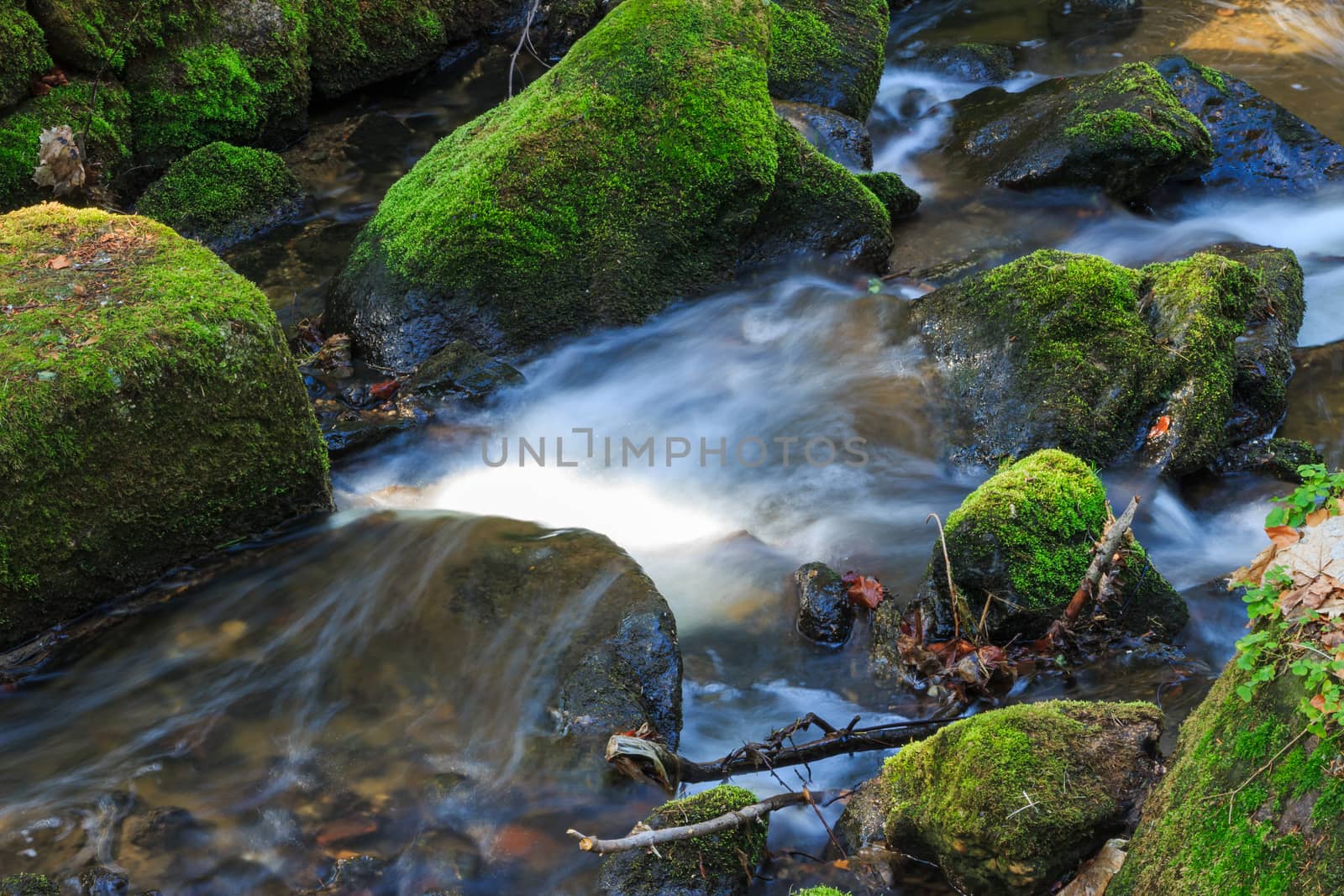 water flowing over rocks by digiart1