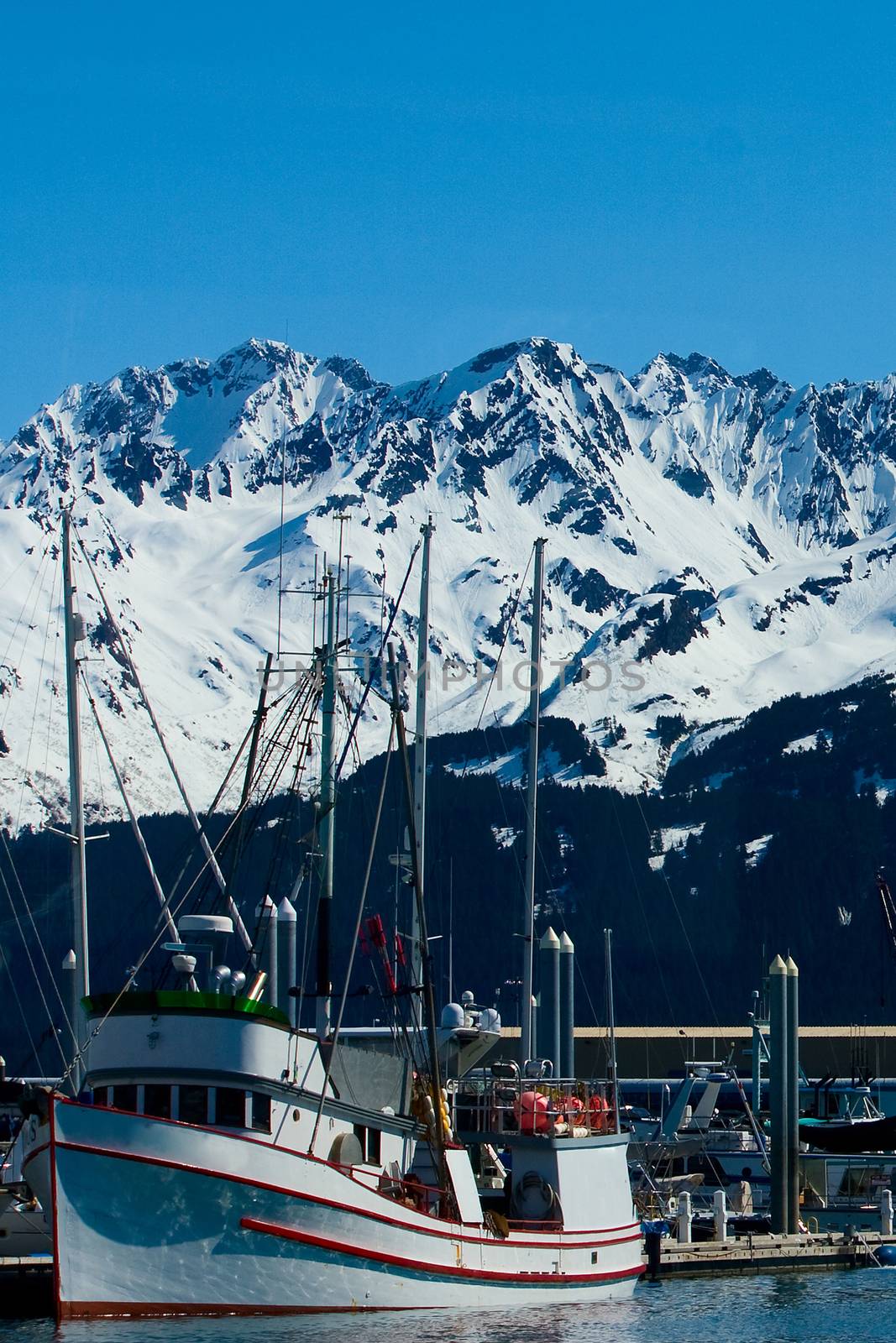 A small red and white boat docked in the harbor in Seward, Alaska. 