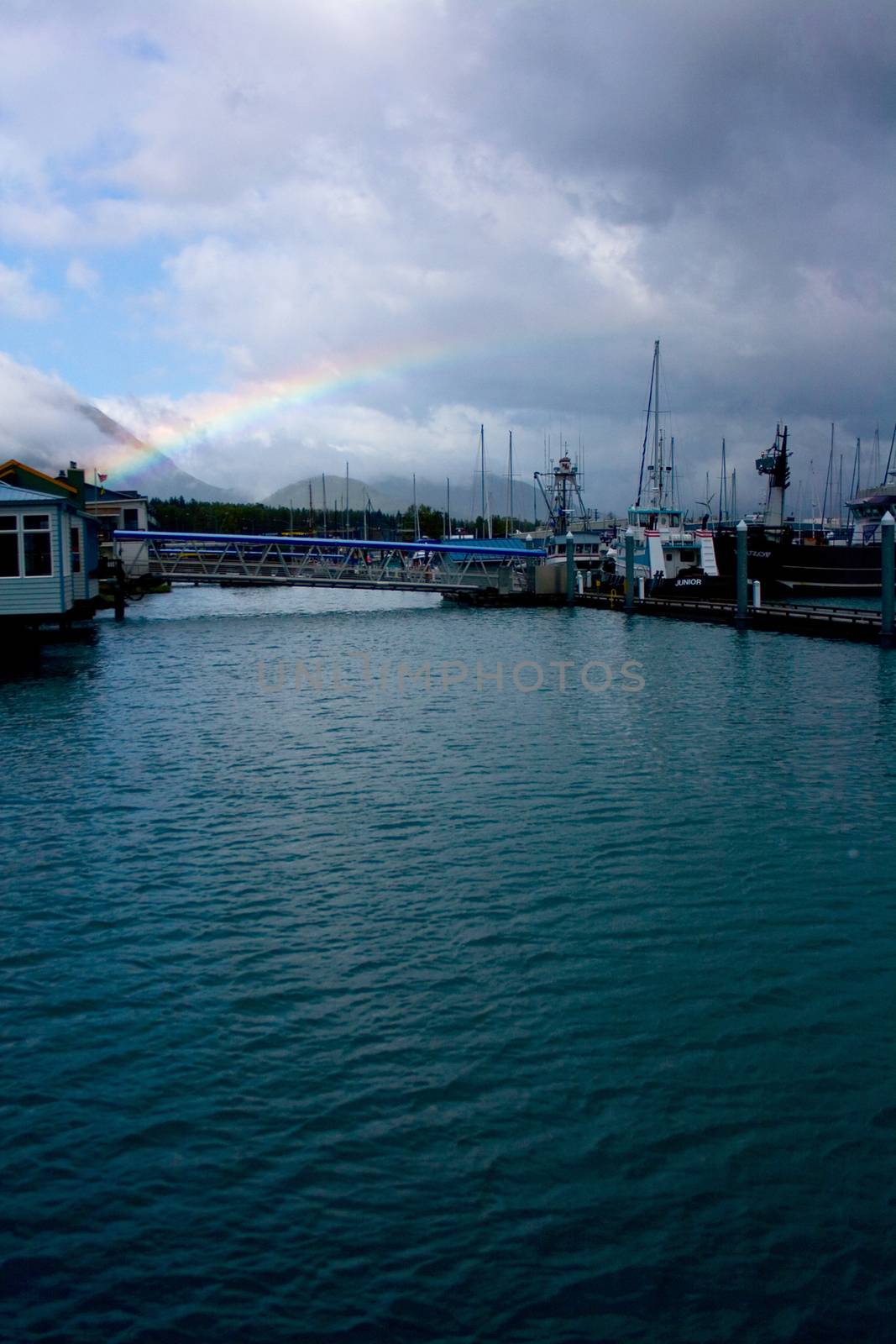 A rainbow forming over the harbor near the city of Seward, Alaska. 
