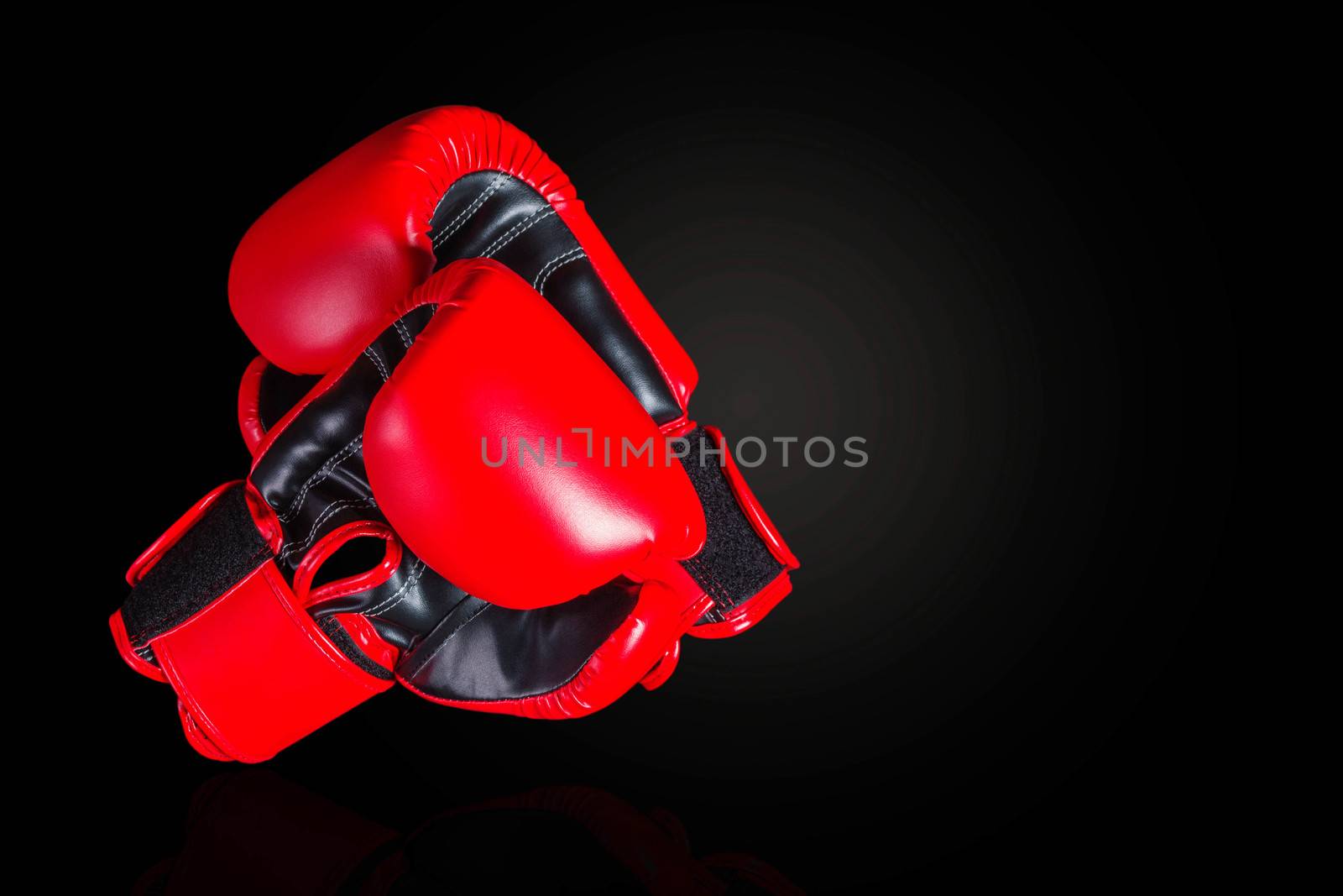 Red boxing gloves on a black background.