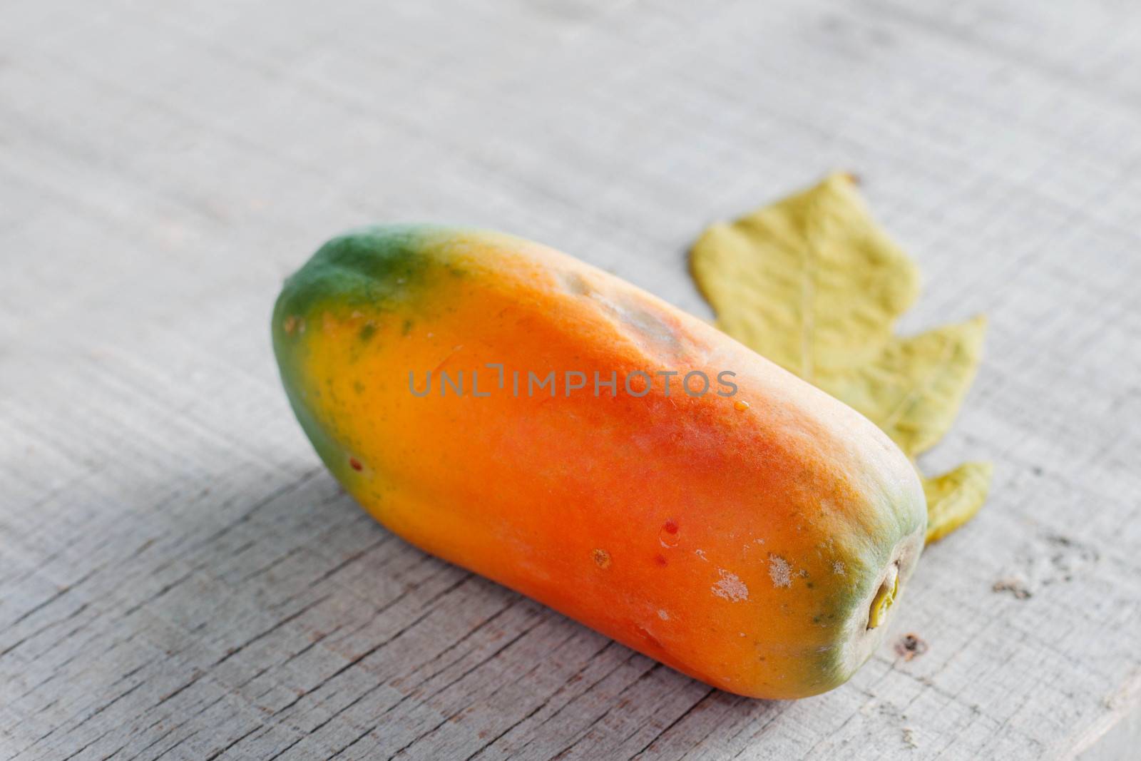 Papaya is ripe on the old wooden floor.